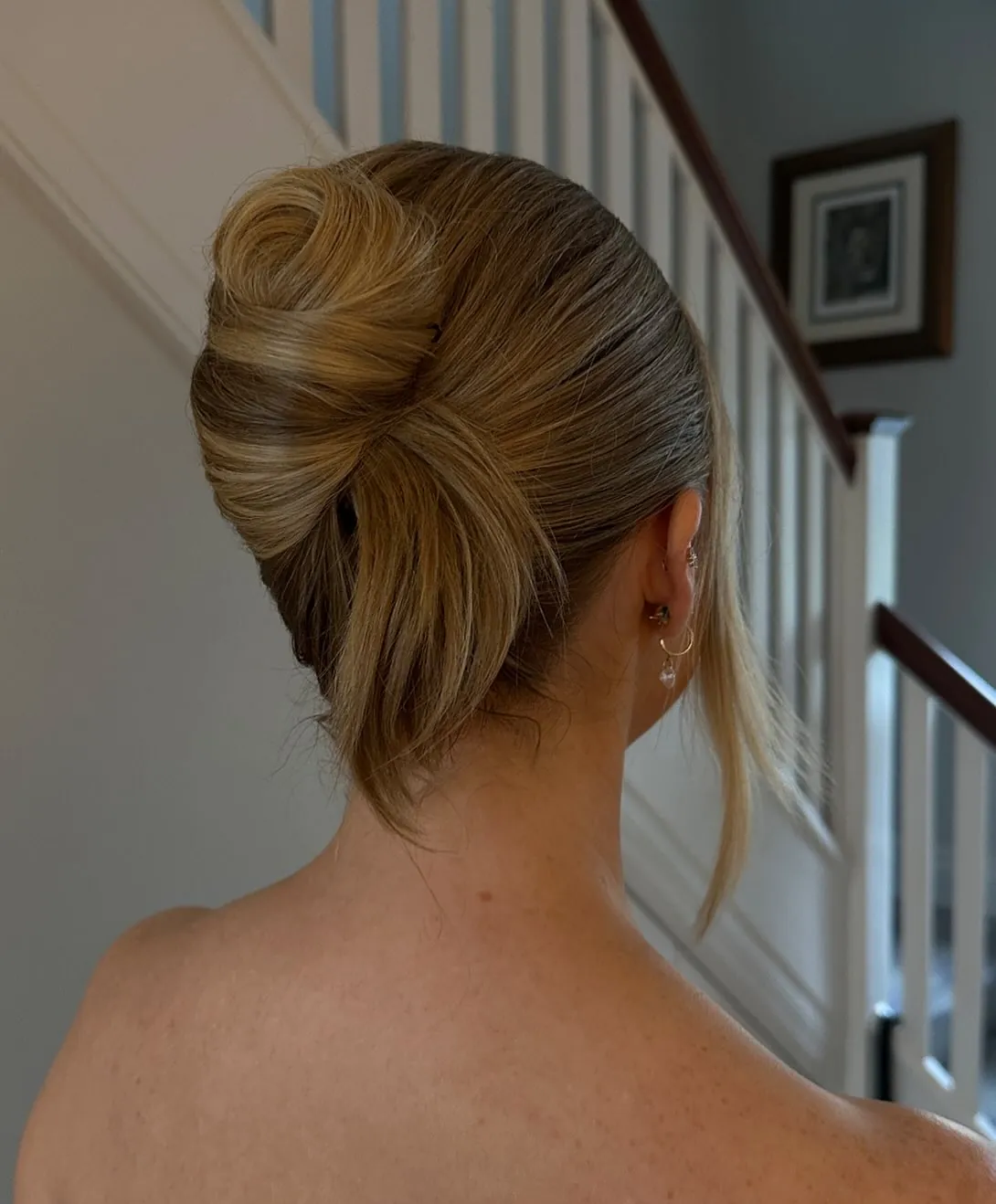 Soft blonde French twist with face framing strand