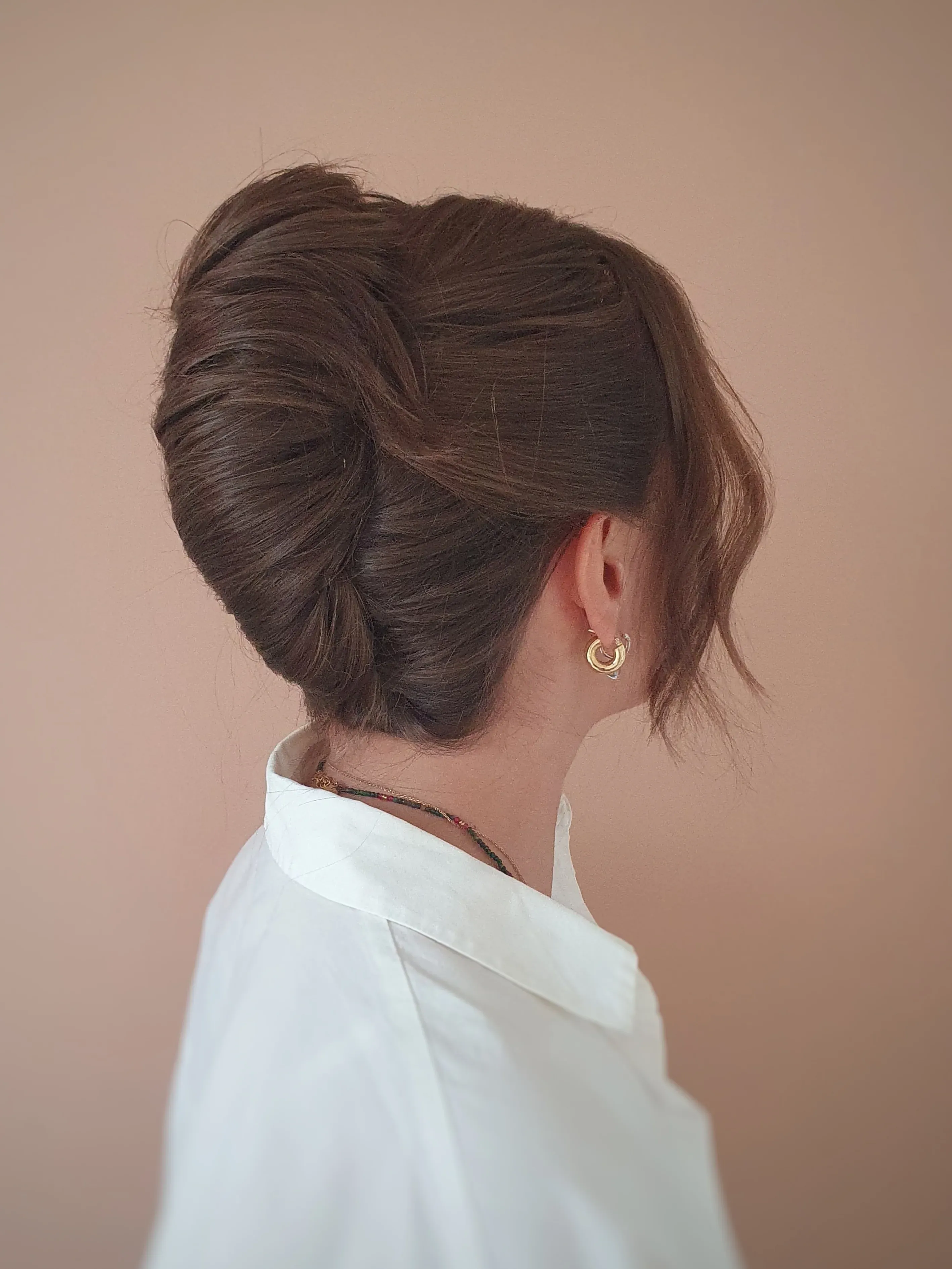 Classic brunette French twist with soft front piece