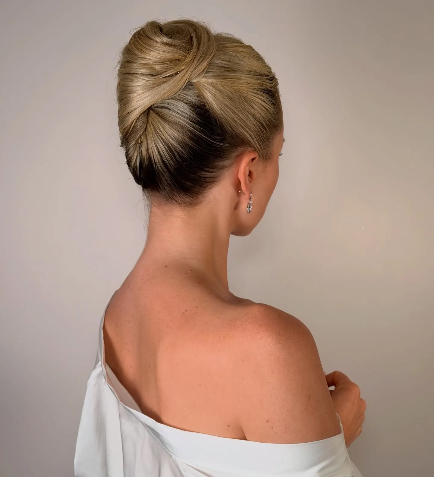Sculpted blonde French twist with smooth vertical seam