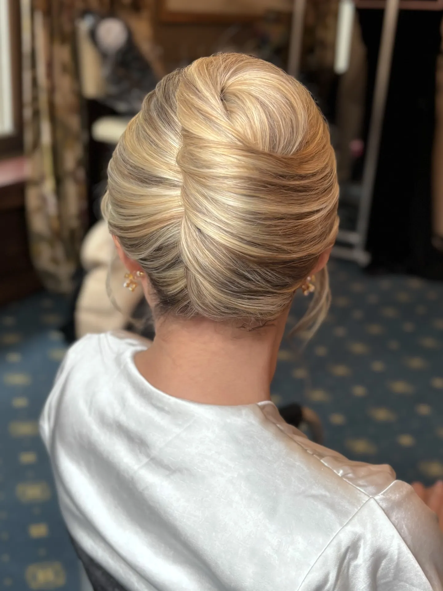 Smooth blonde bridal French twist