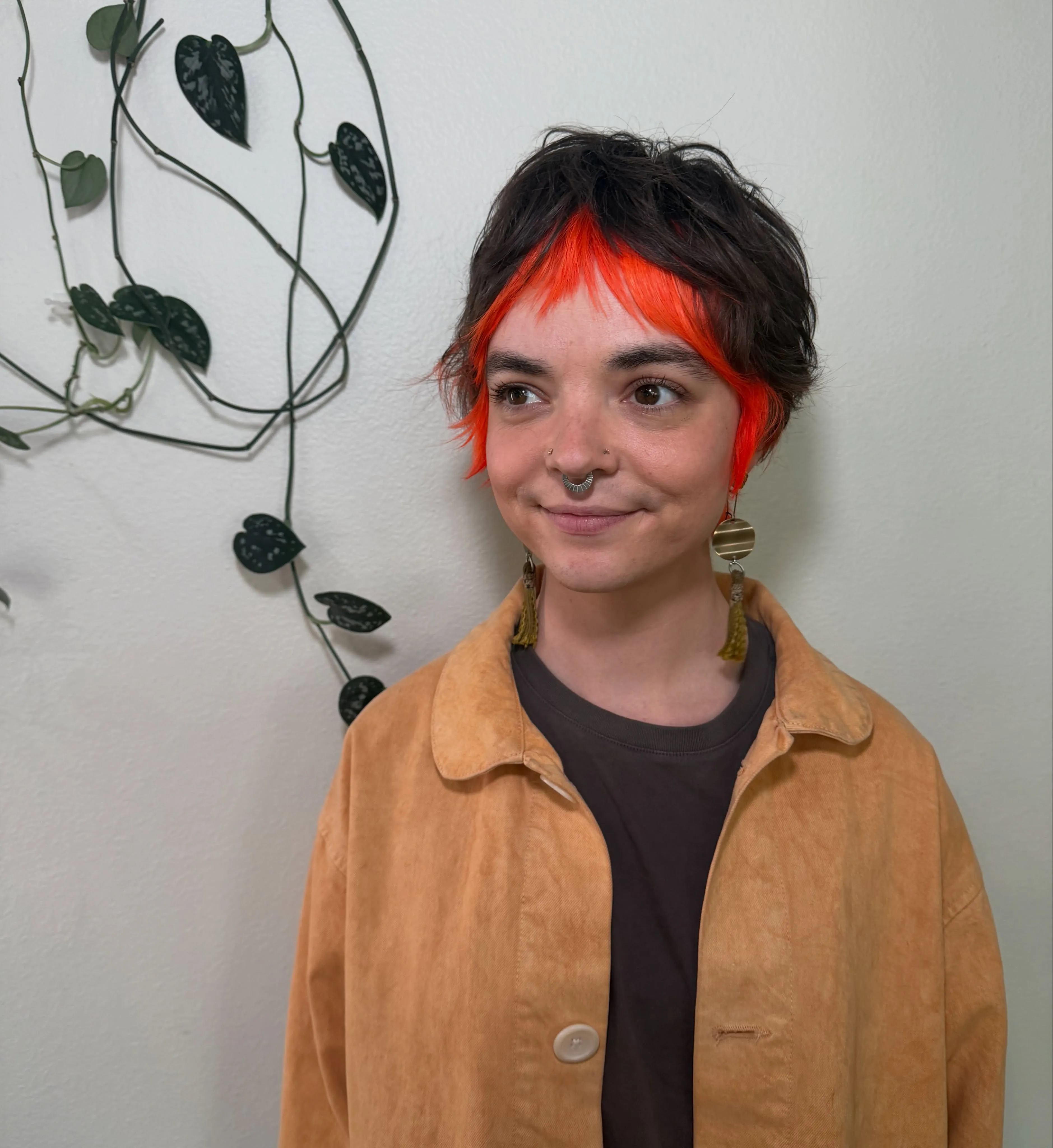 Dark pixie with vivid red face-framing fringe and wispy layers
