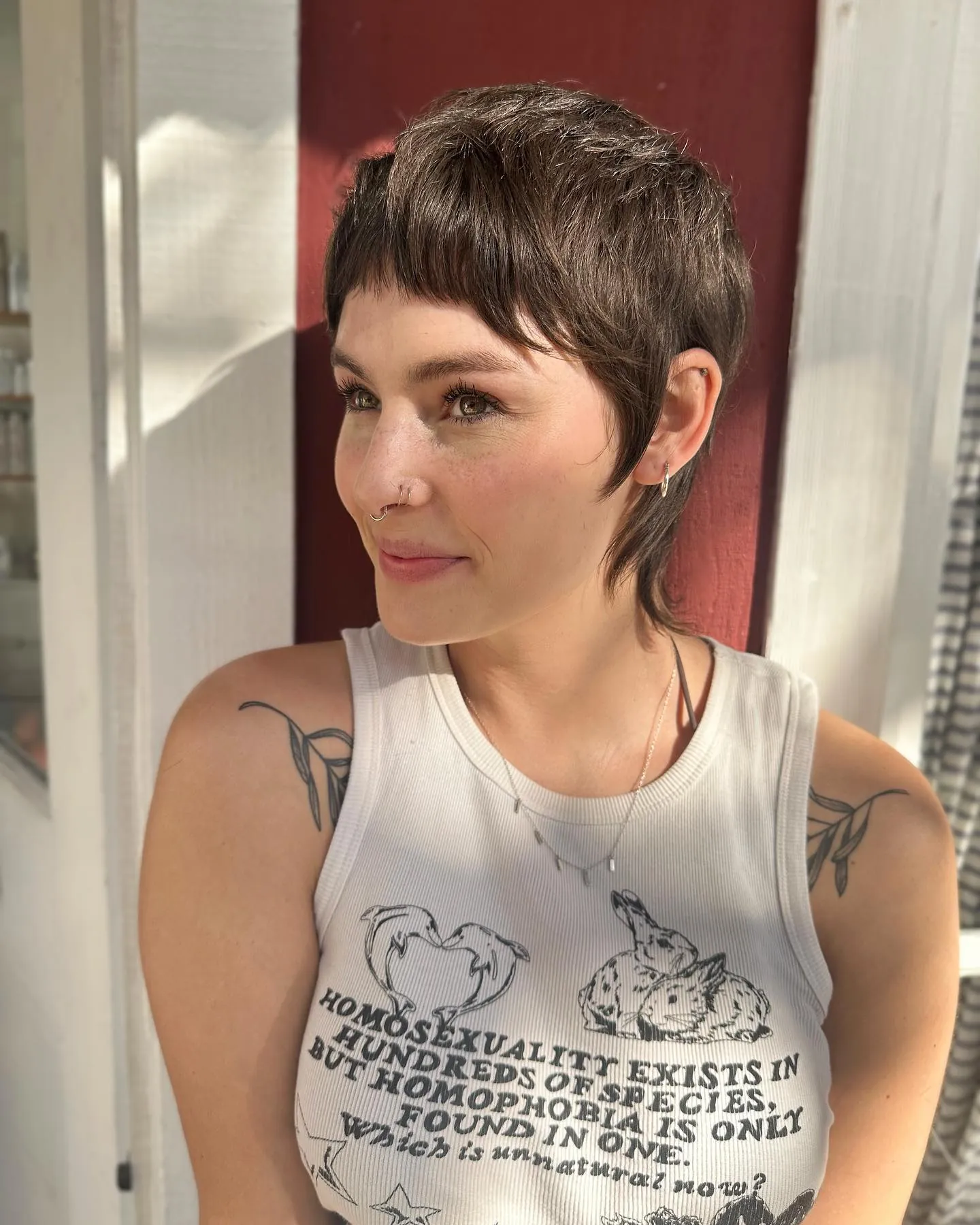 Dark pixie mullet with micro fringe and longer nape pieces