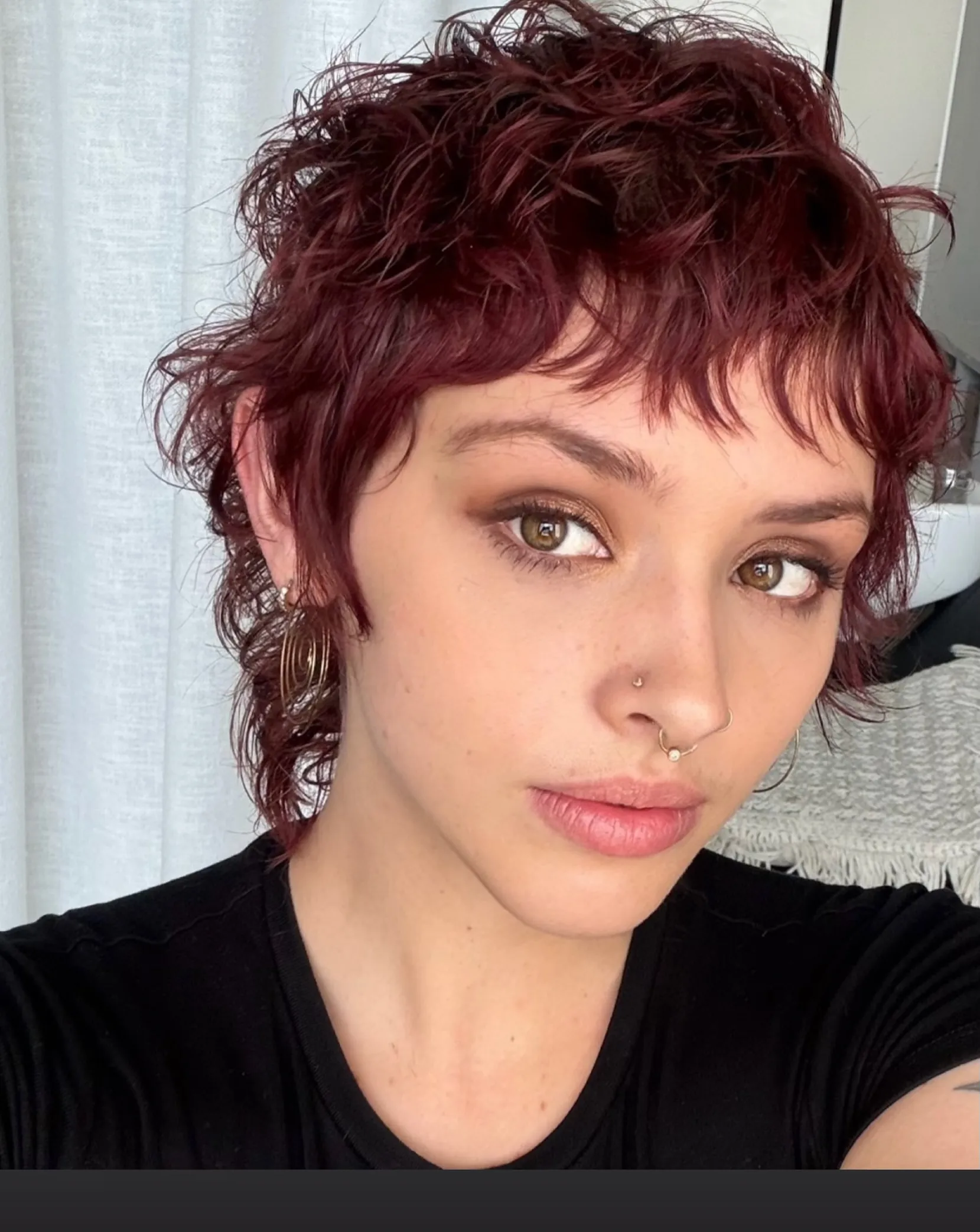 Burgundy curly pixie with piecey fringe and longer side wisps
