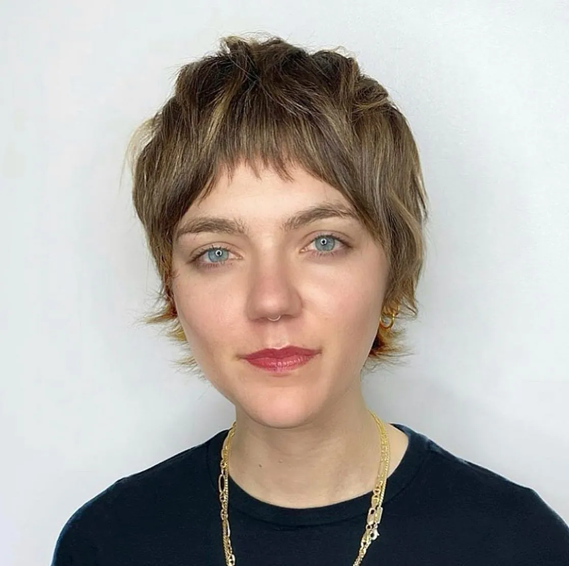 Sandy brown pixie with feathered fringe and flicked side pieces