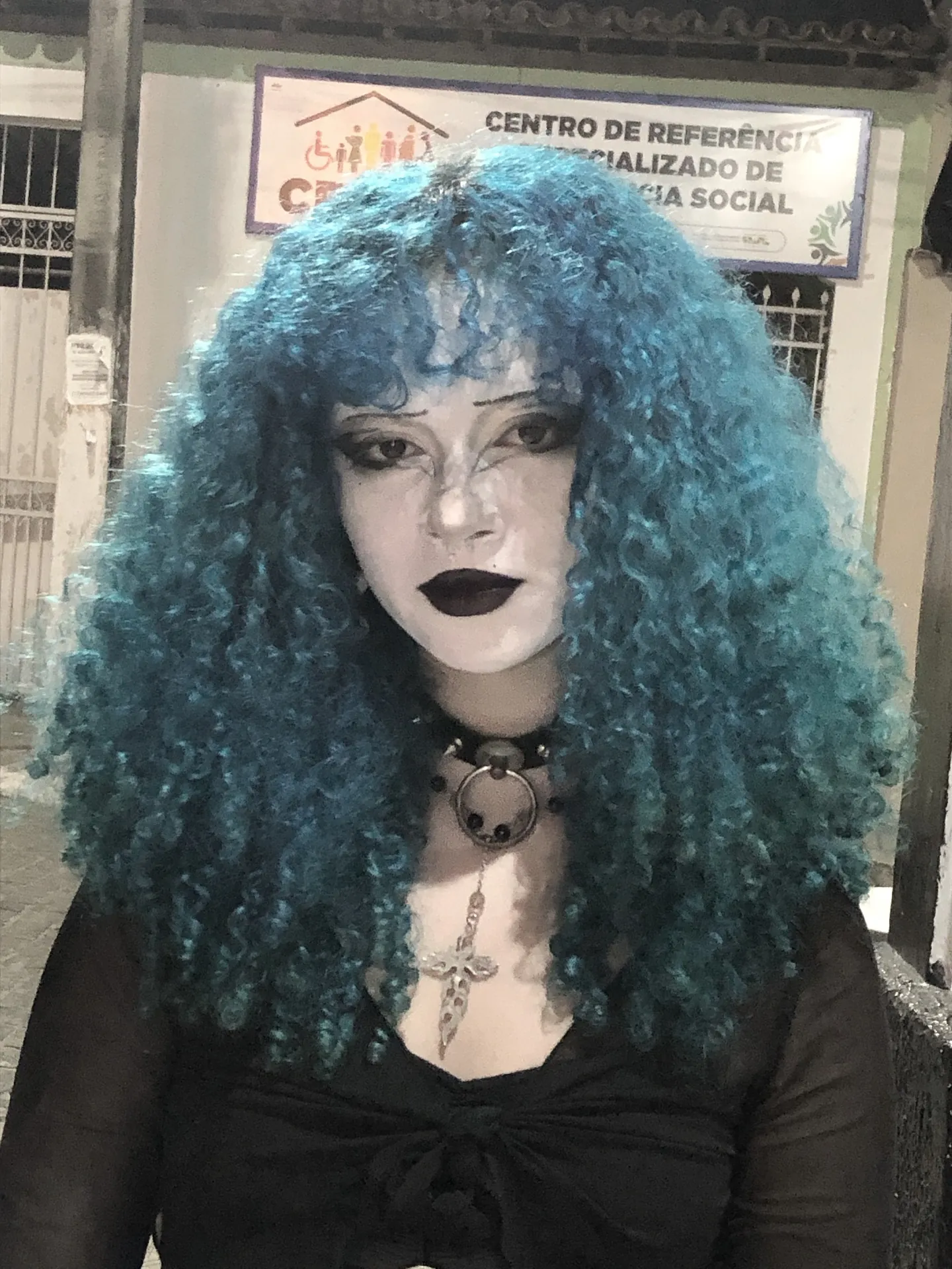 Teal curly shag with full rounded volume and bangs
