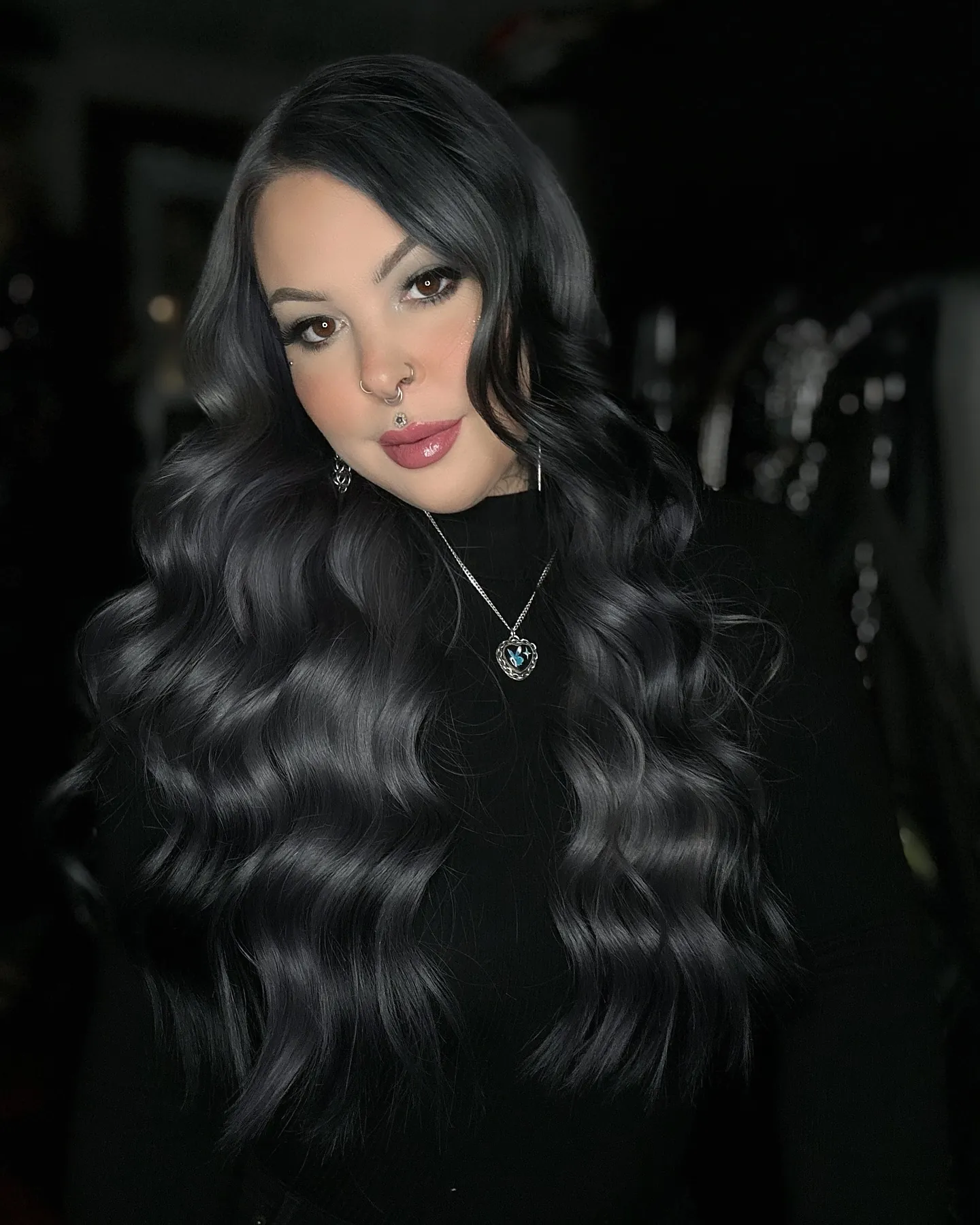 Long glossy black hair styled in broad S-waves