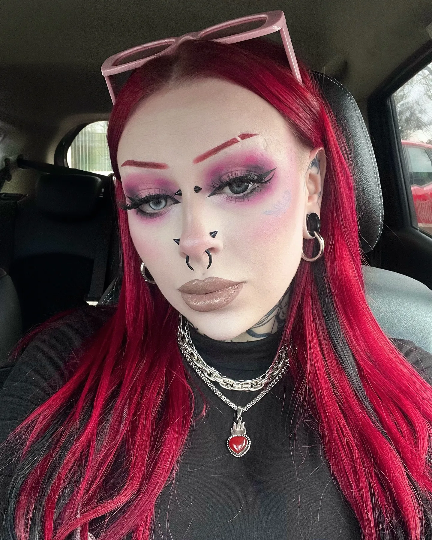 Long vivid red hair with black contrast sections