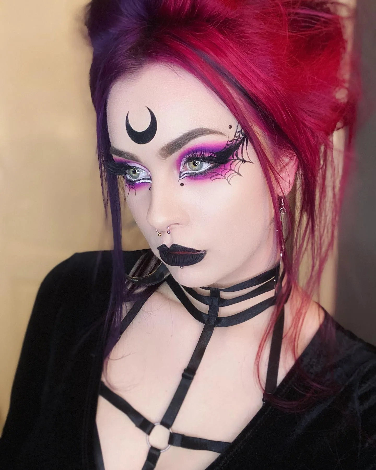 Red and purple textured high updo with long face-framing strands