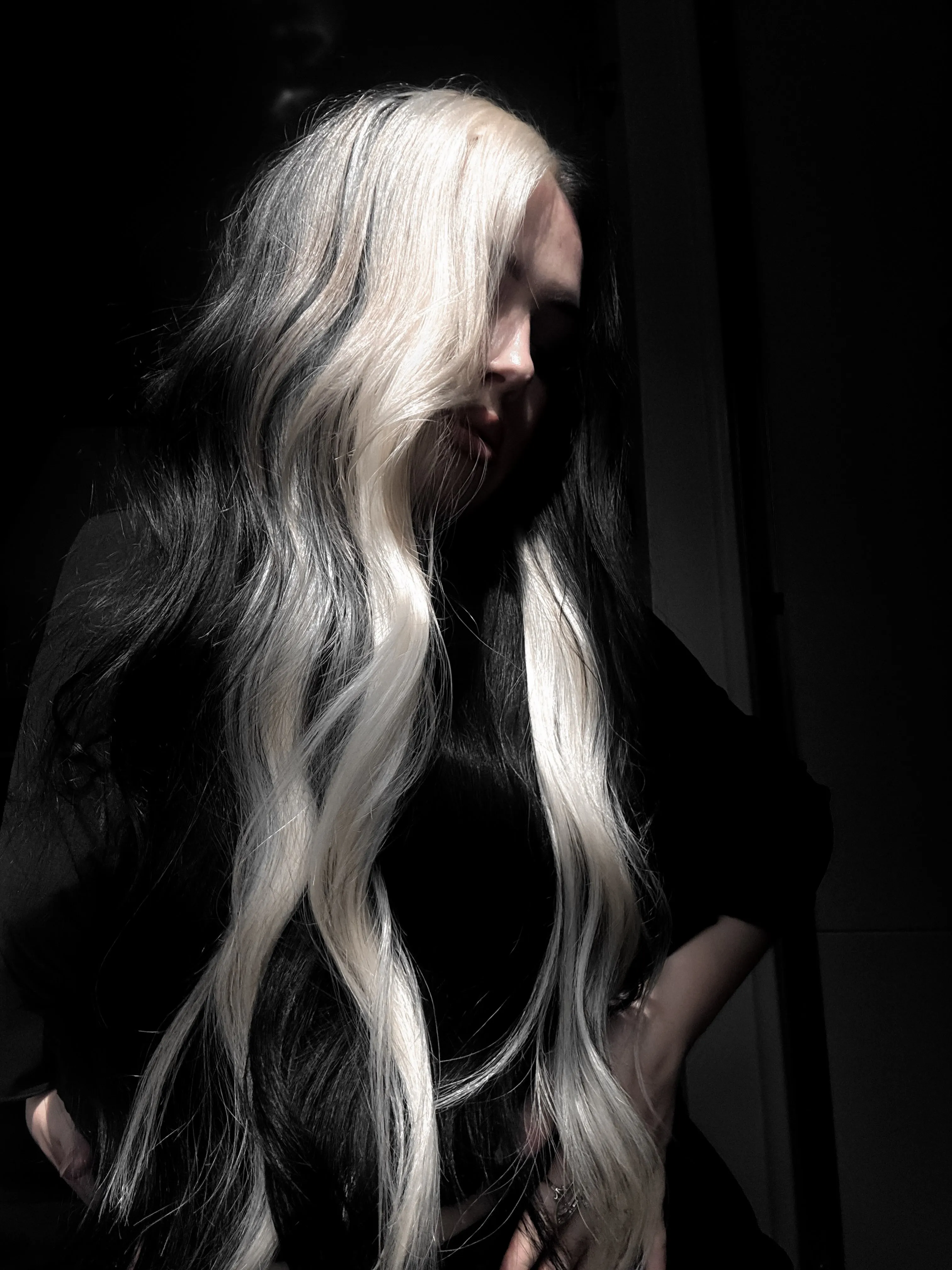 Long black and silver split-dye hair with loose waves