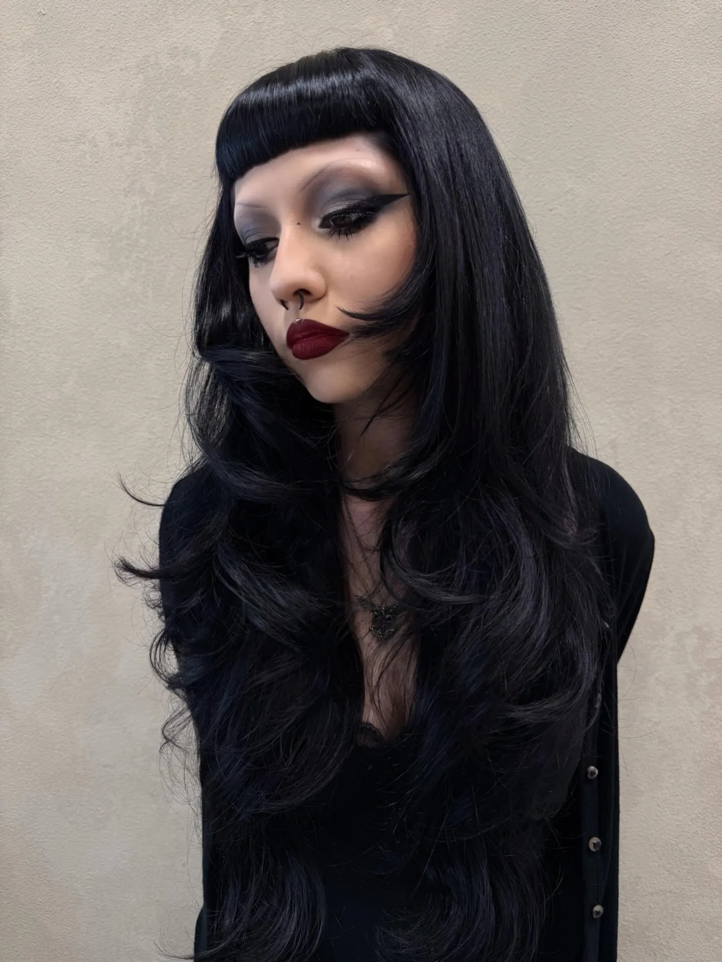Long black layered hair with smooth face-framing waves