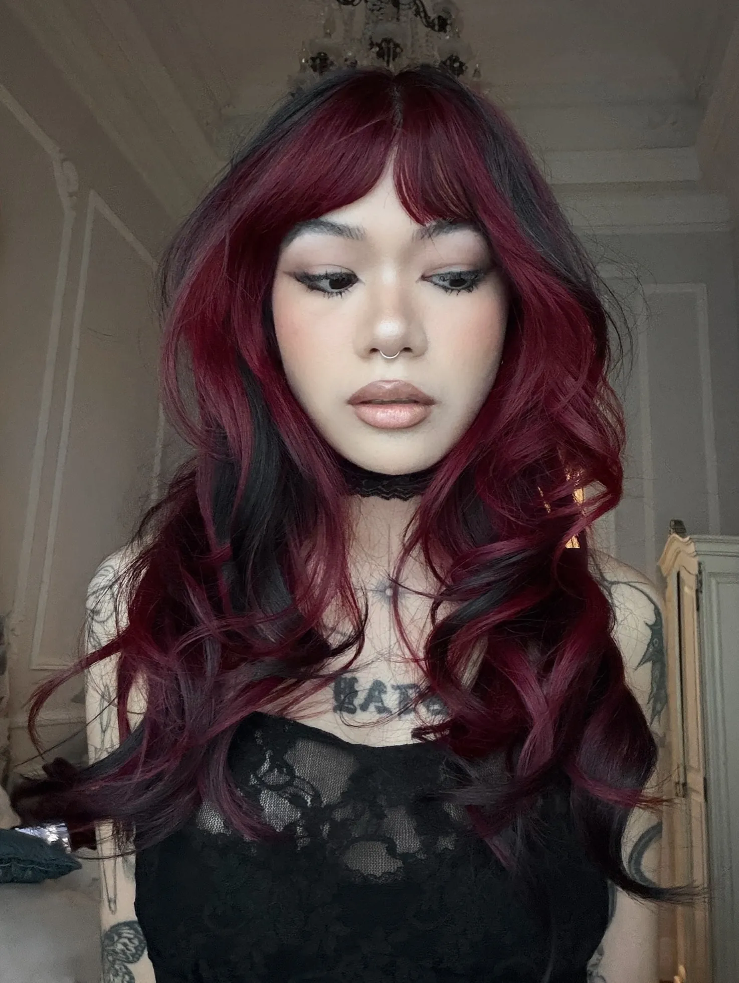 Long burgundy loose waves with curtain bangs