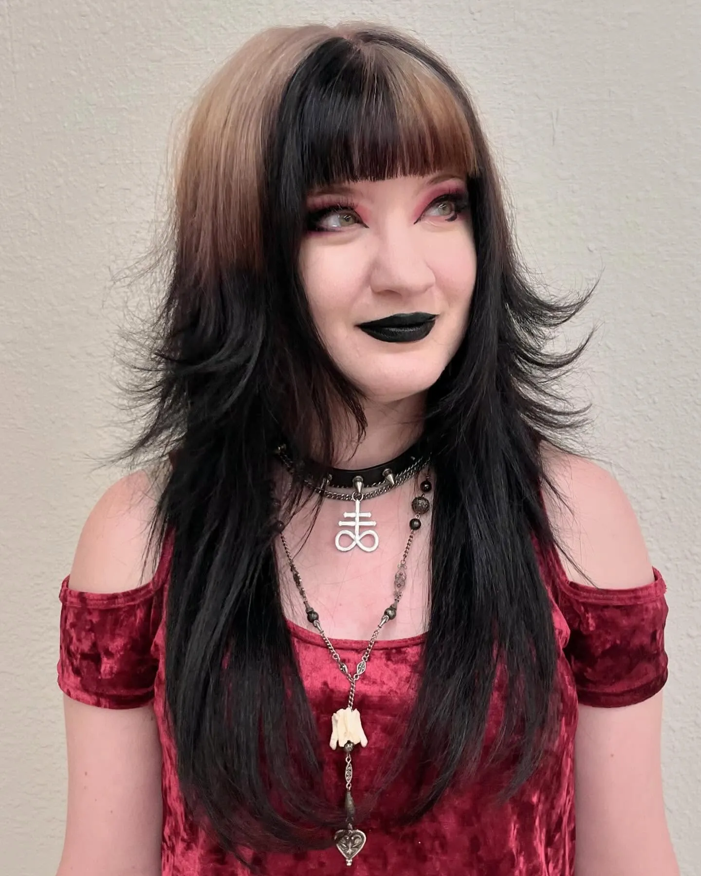 Long layered black shag with blunt bangs and flipped ends