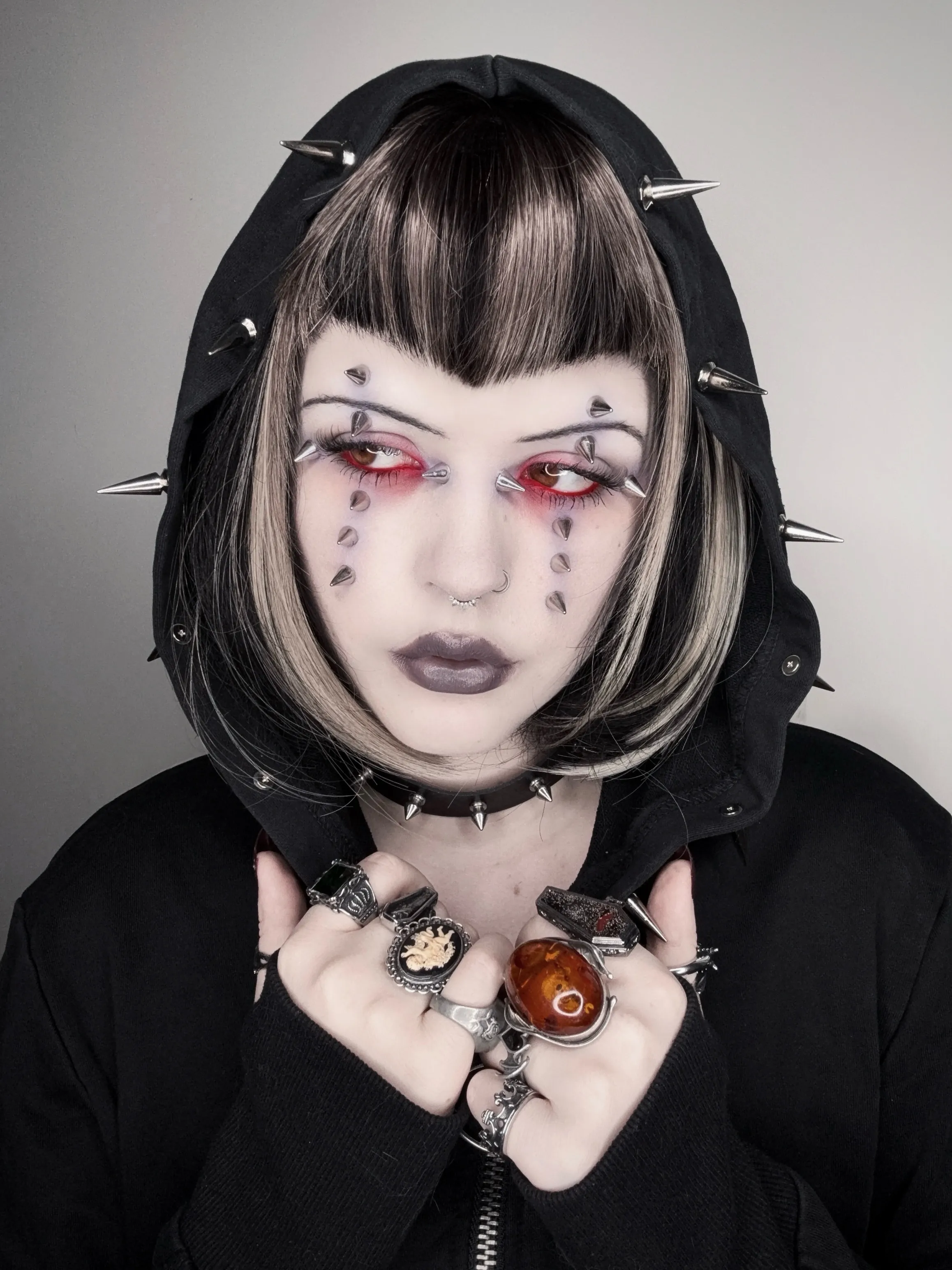 Rounded black bob with pale face-framing panels and baby bangs