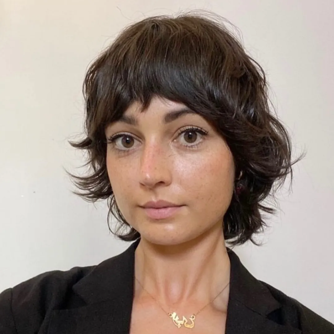 Short dark halo haircut with rounded fringe and flicked sides