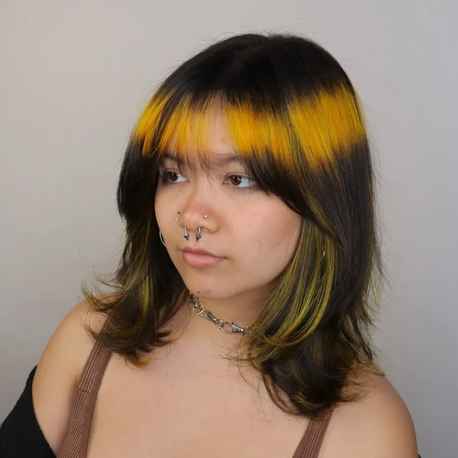 Dark halo haircut with bright graphic fringe colour