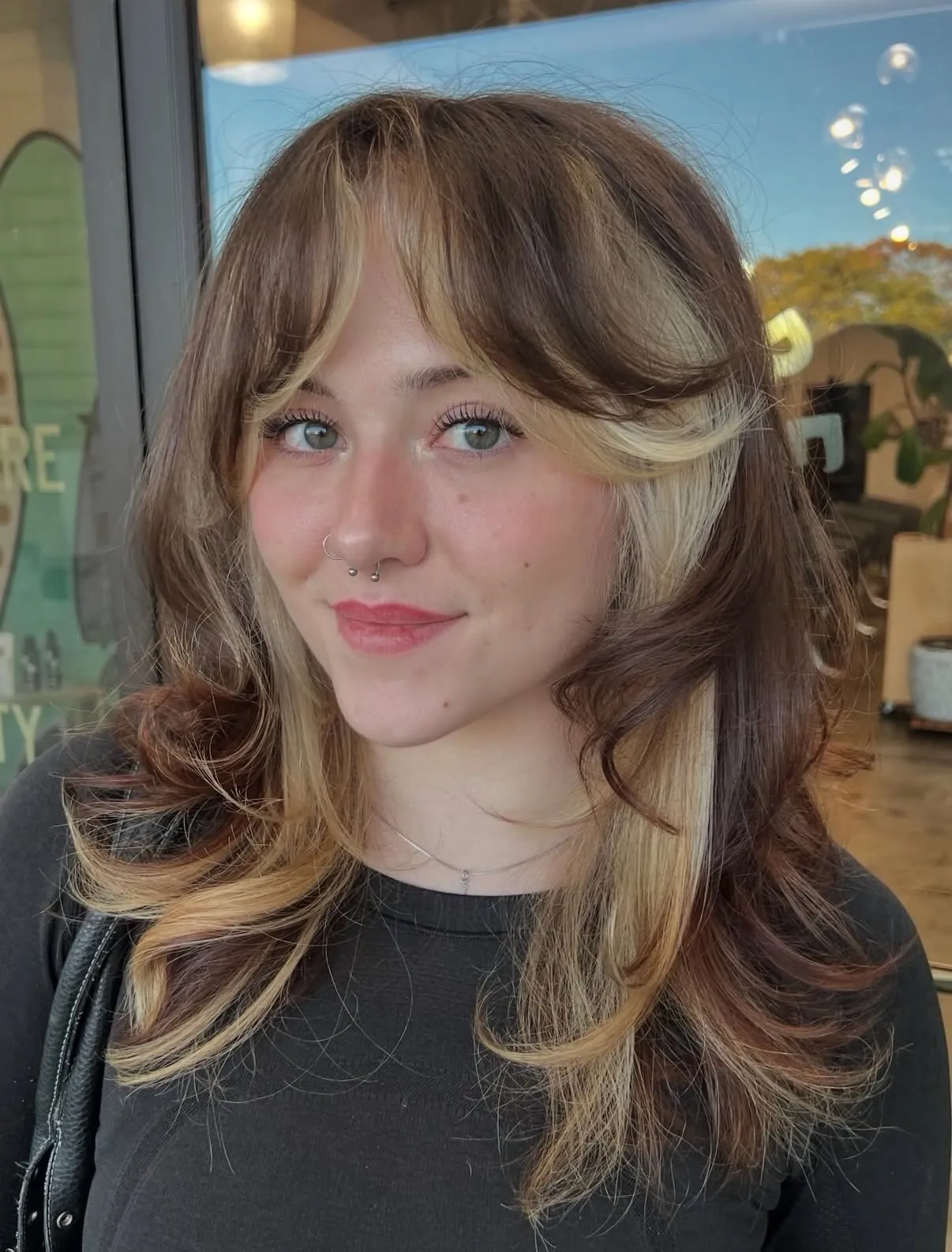 Feathered halo haircut with blonde face framing