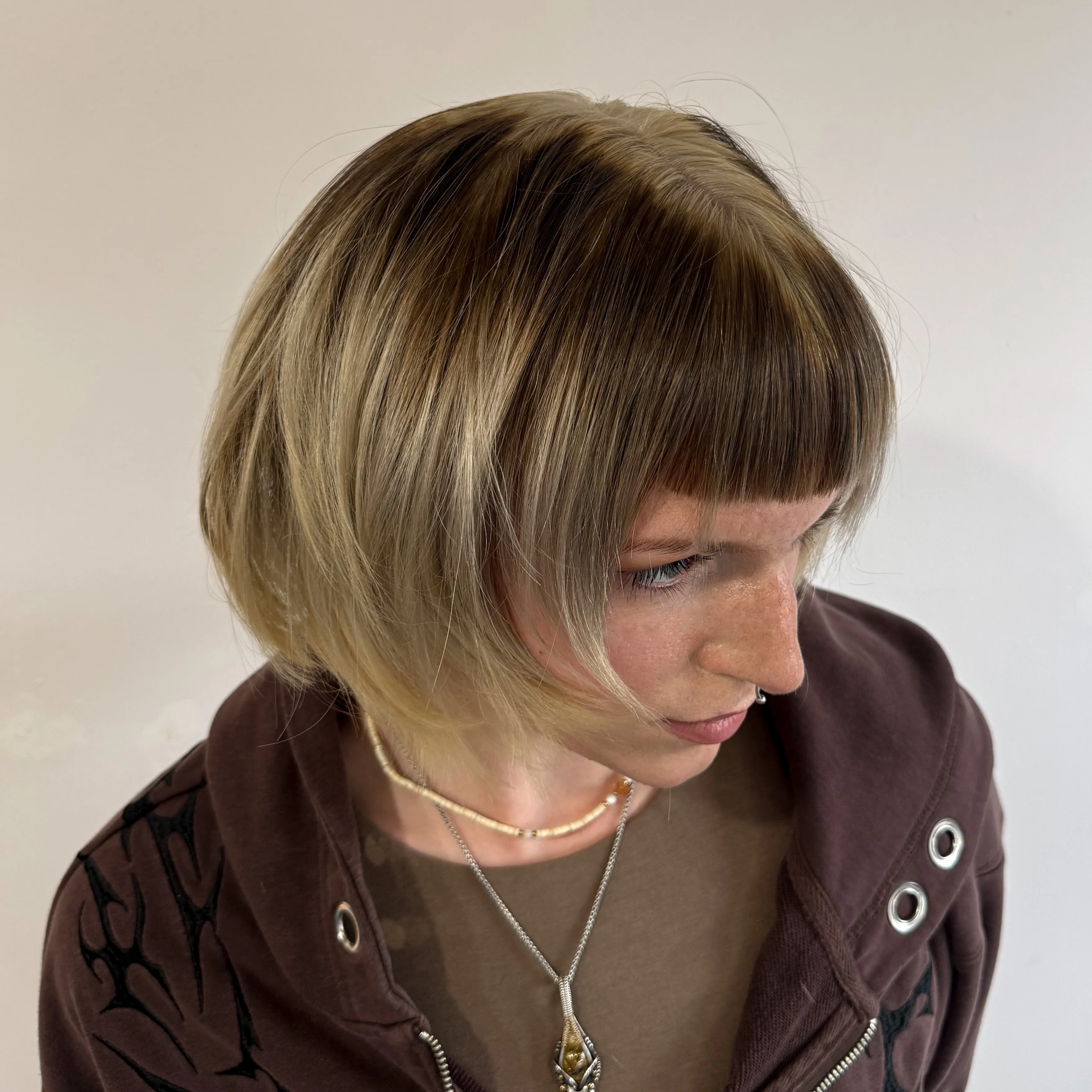 Short rounded halo haircut with smooth curved fringe