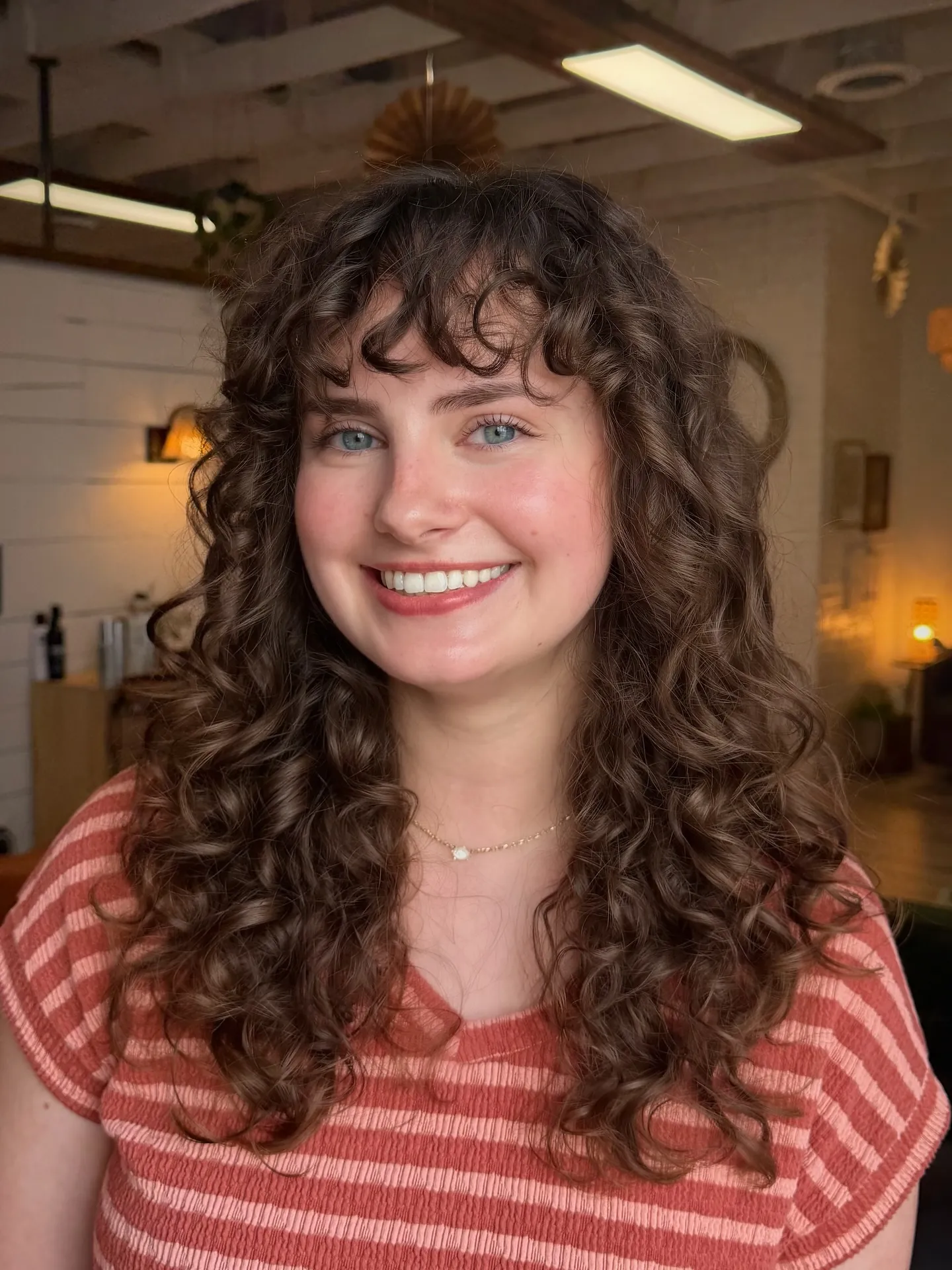 Long brunette curls with bangs and layered movement