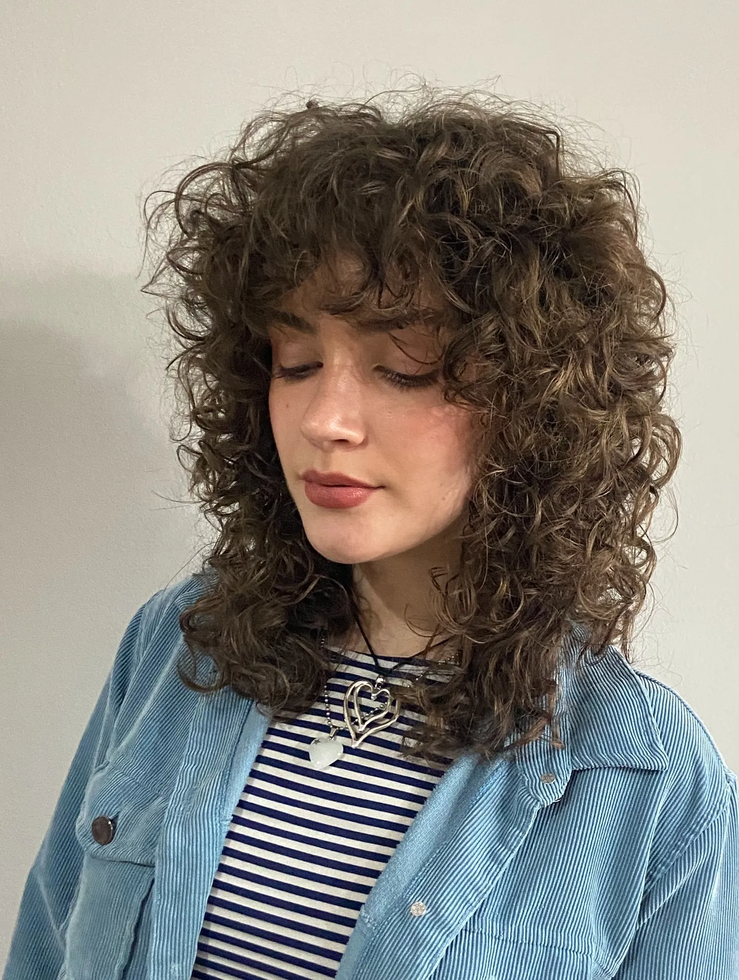 Full fringe curly shag with textured shoulder layers