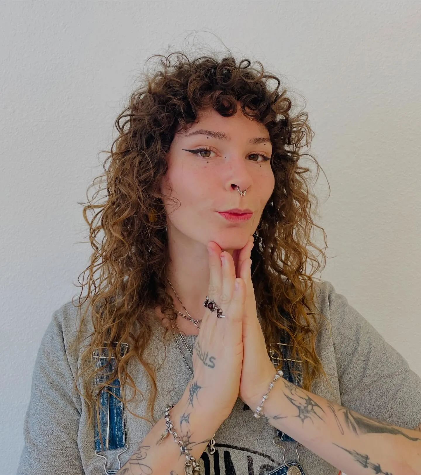 Long ginger curls with short bangs and layered ends