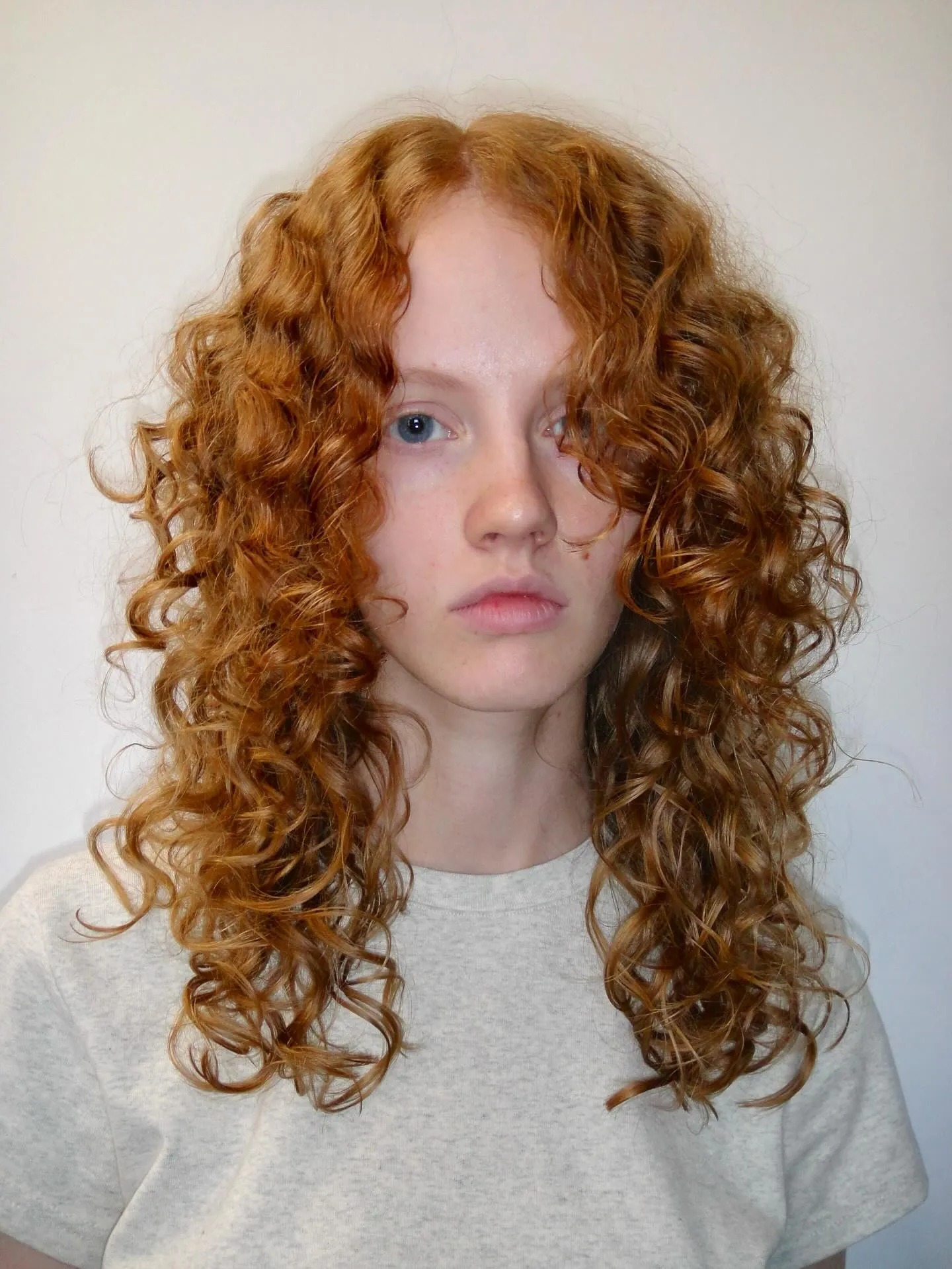 Long ginger curls with centre part and layered lengths