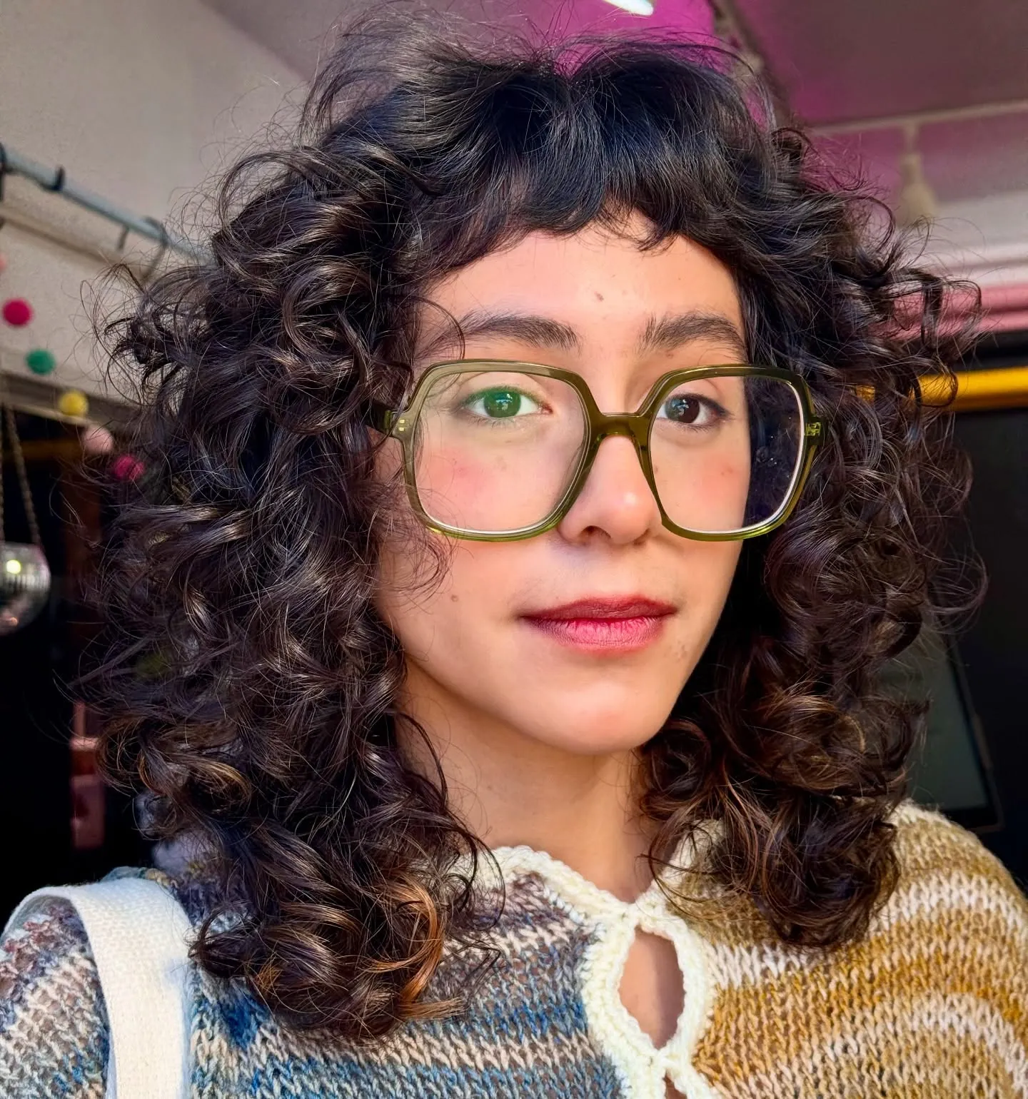 Curly bob with short bangs and rounded volume