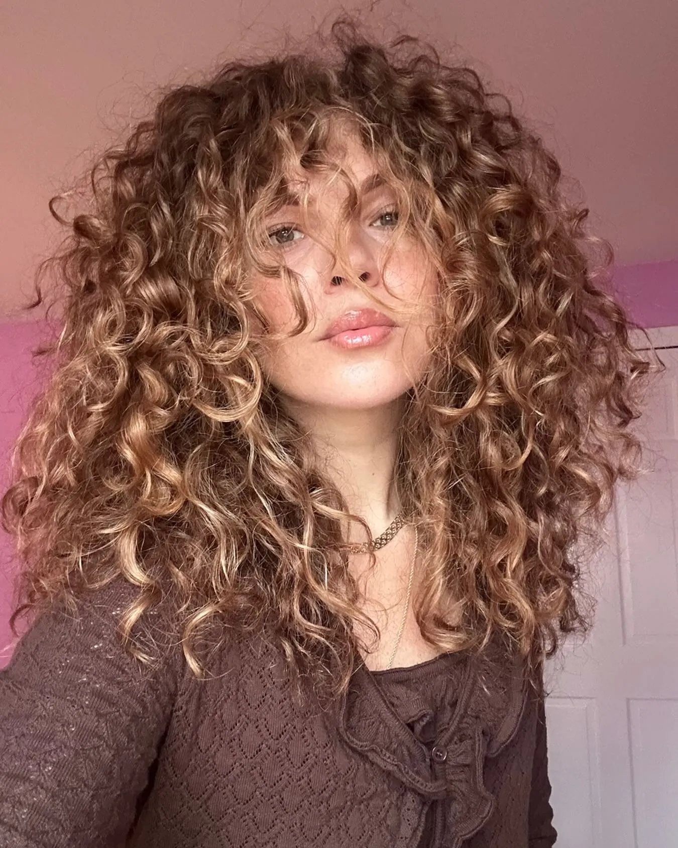 Voluminous long curls with soft fringe and layered shape