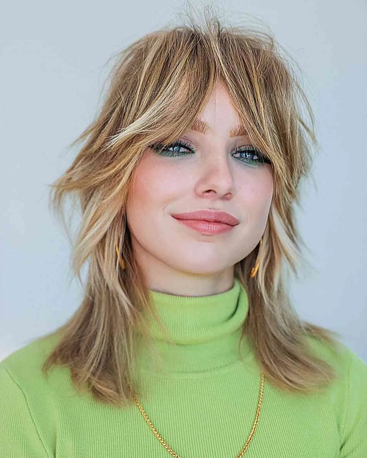 Feathered shoulder-length lob with wispy curtain bangs
