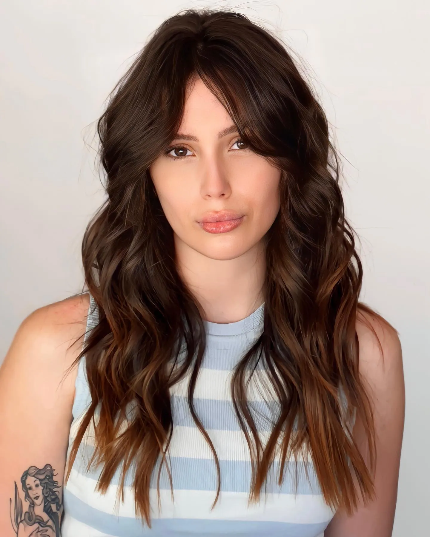 Long wavy layers with center-parted curtain bangs