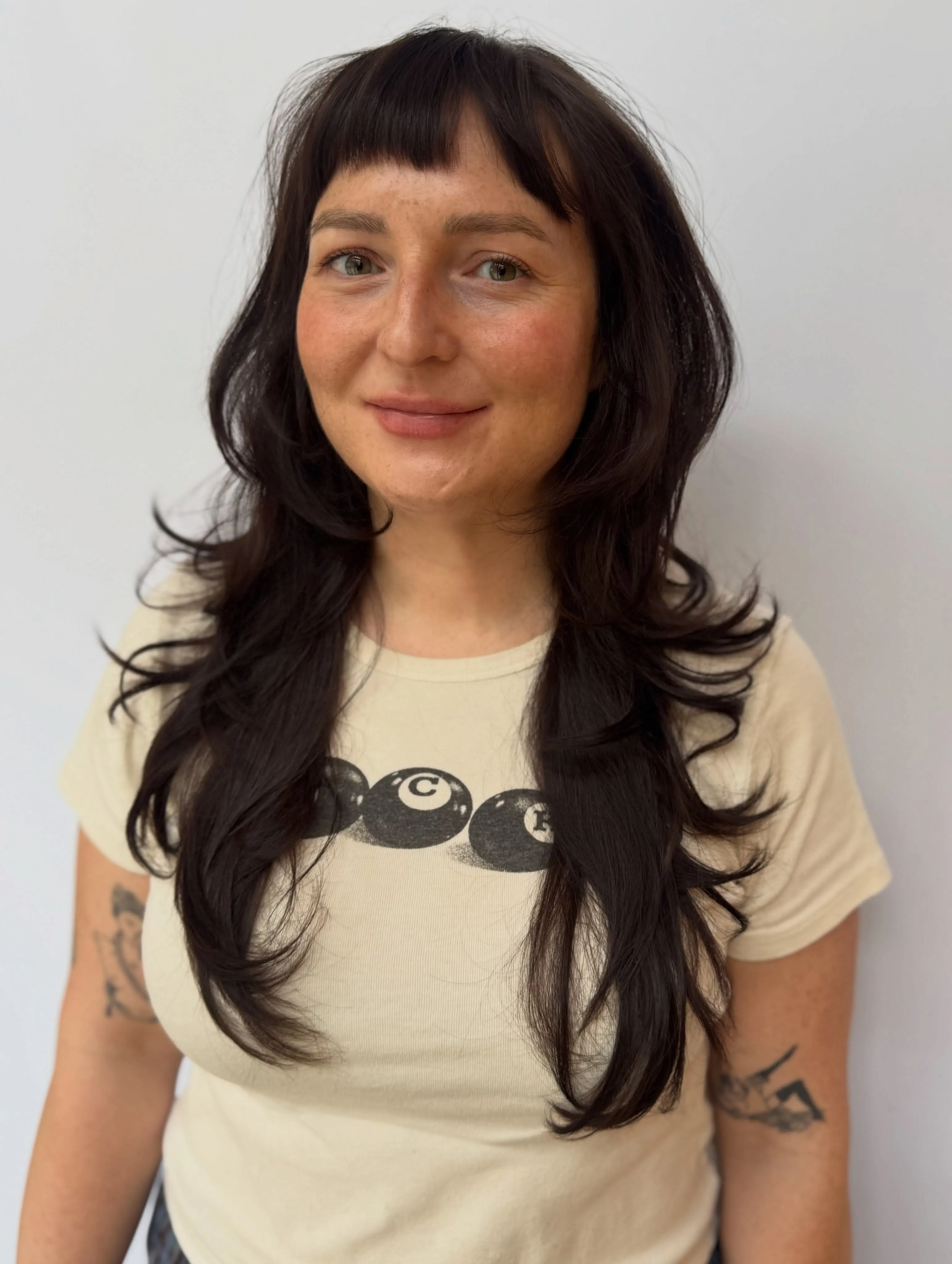 Long dark shag layers with short full bangs
