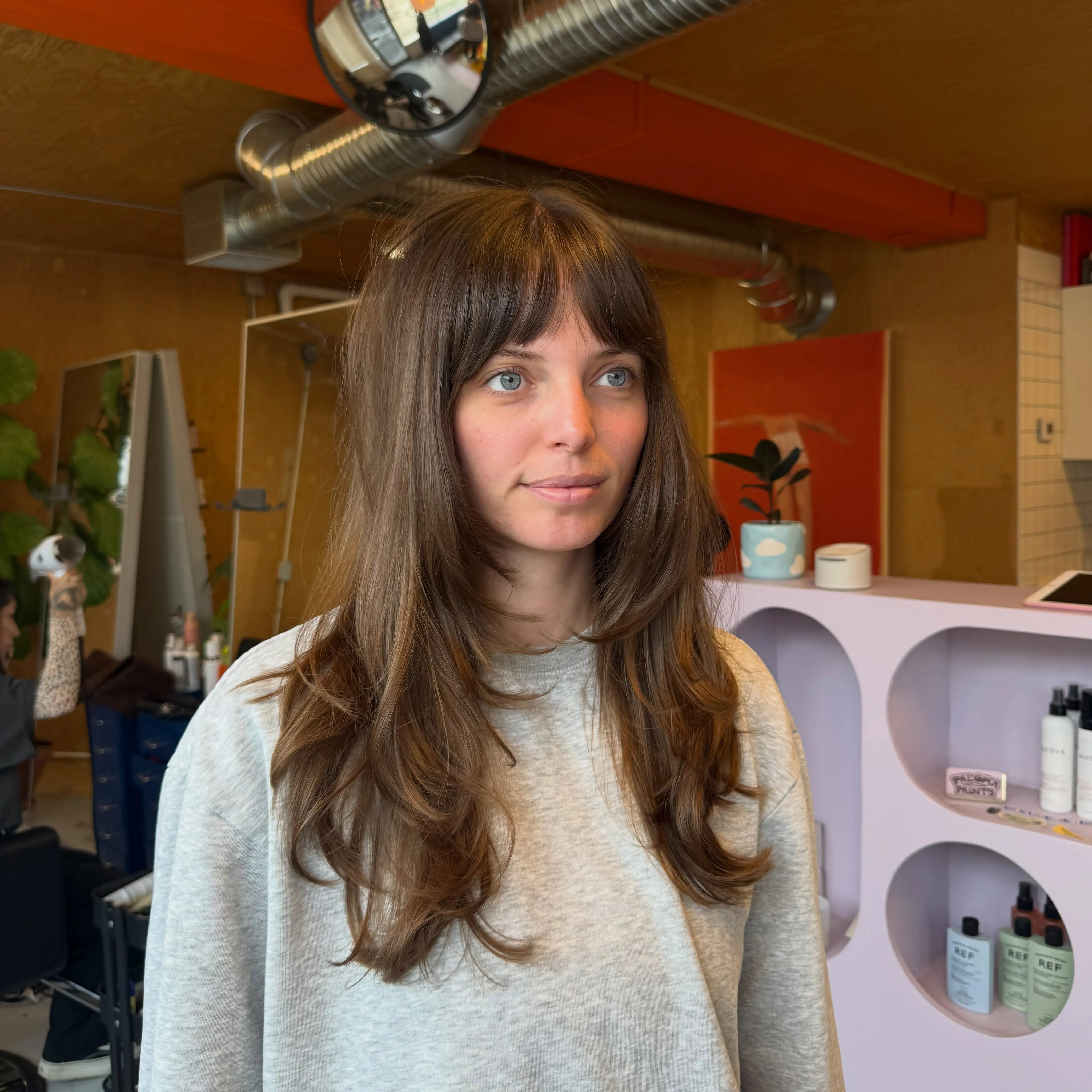 Long brunette layers with soft straight fringe
