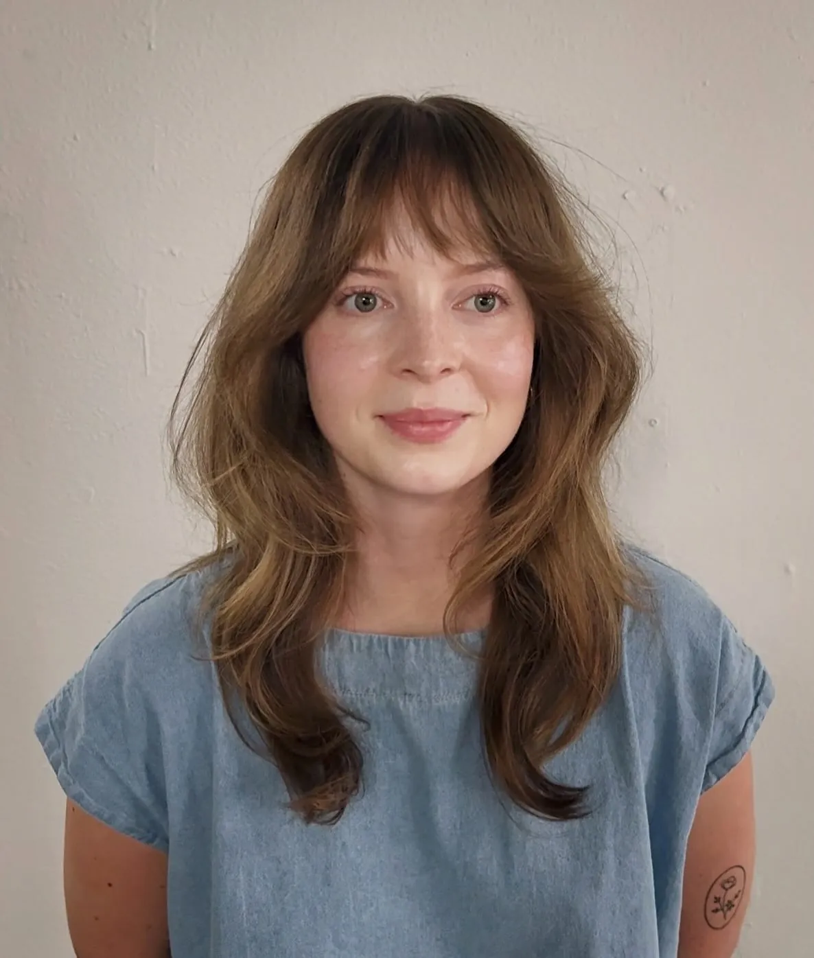 Long soft layers with curtain bangs and rounded ends