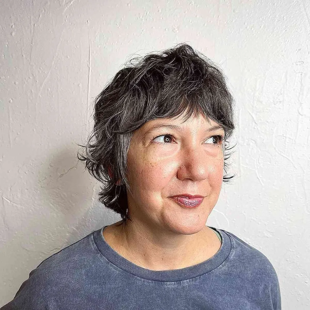 Curly layered bixie with wispy fringe and longer sides