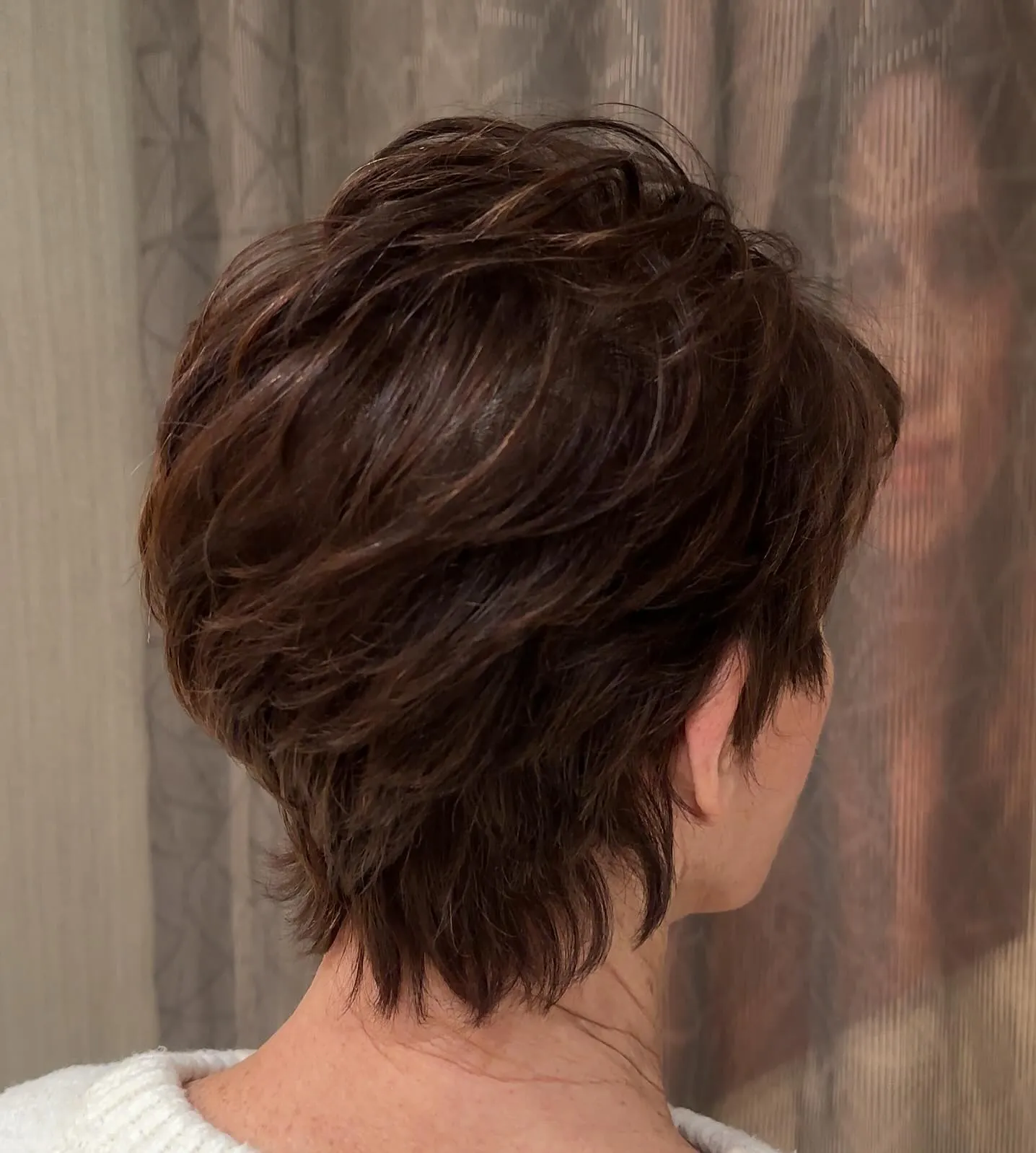 Shaggy layered pixie with longer textured nape