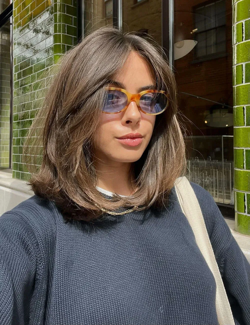 Brown long bob with center part and feathered face-framing ends