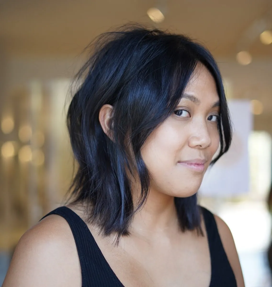 Dark layered long bob with loose waves and face-framing pieces
