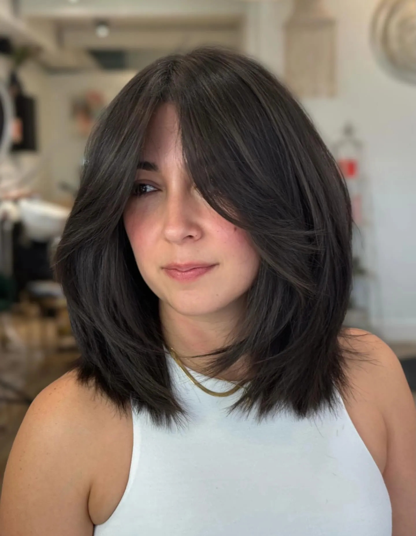 Dark rounded long bob with long curtain layers and soft face framing