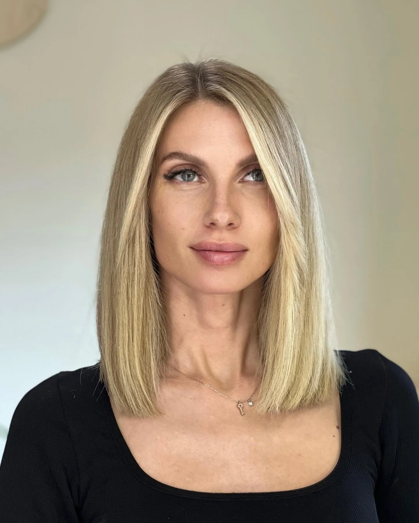 Blonde center-part long bob with straight blunt shoulder-length ends