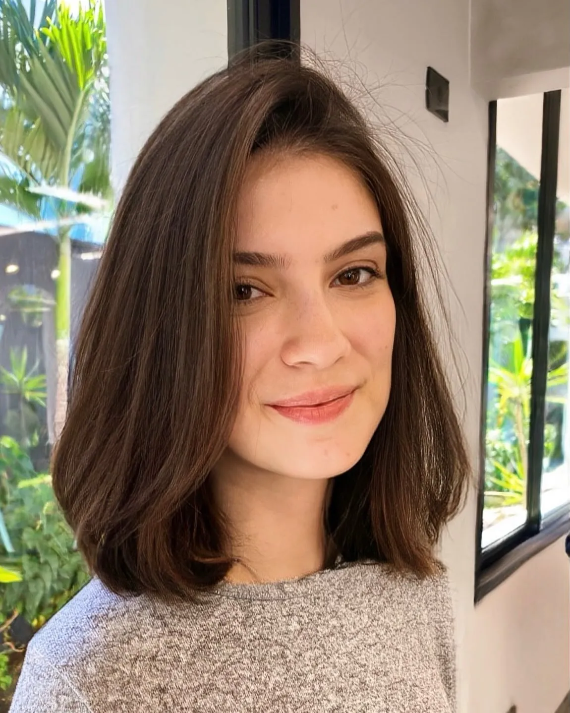 Smooth brown side-parted long bob with blunt shoulder-length ends