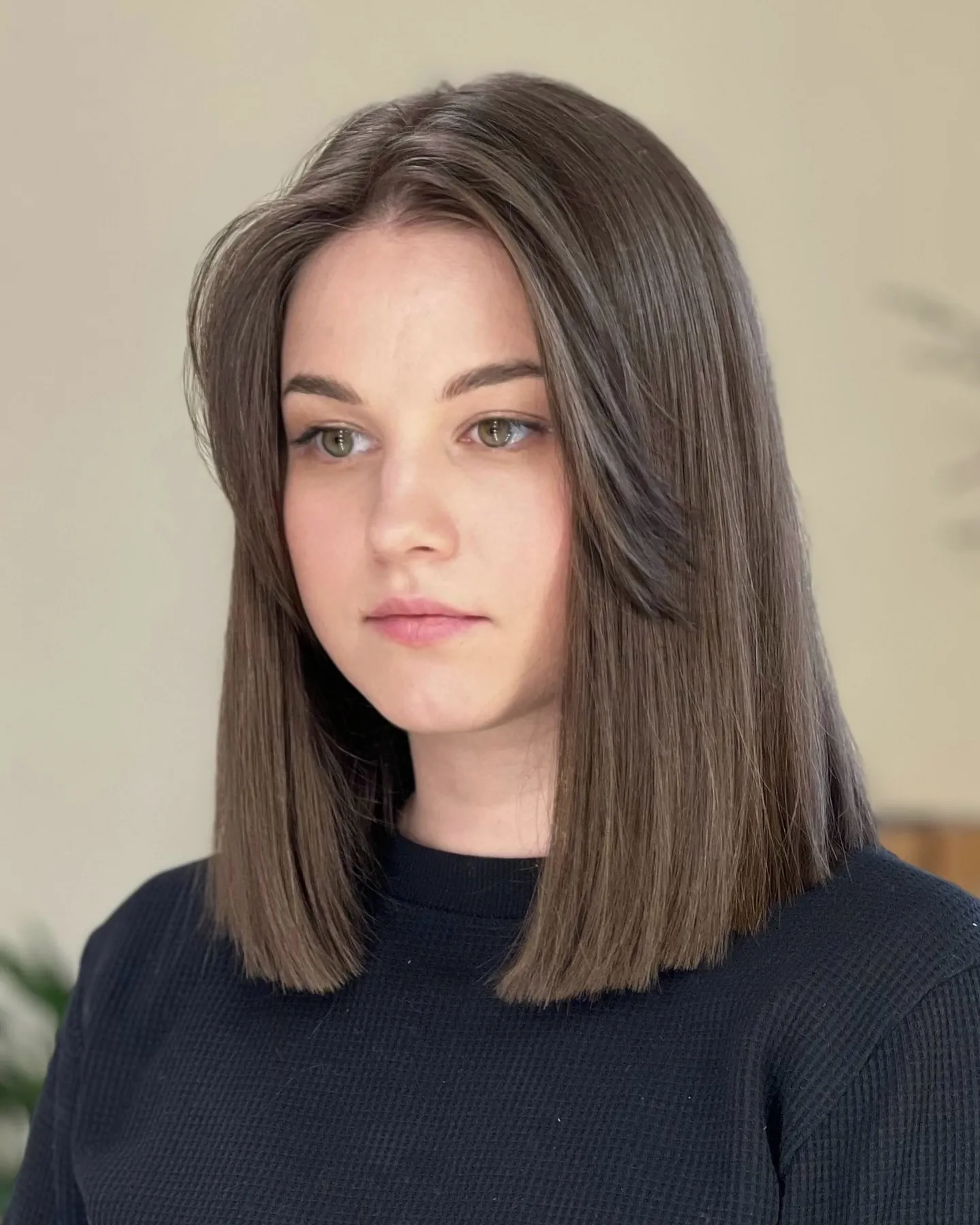 Straight brunette center-part long bob with crisp blunt ends