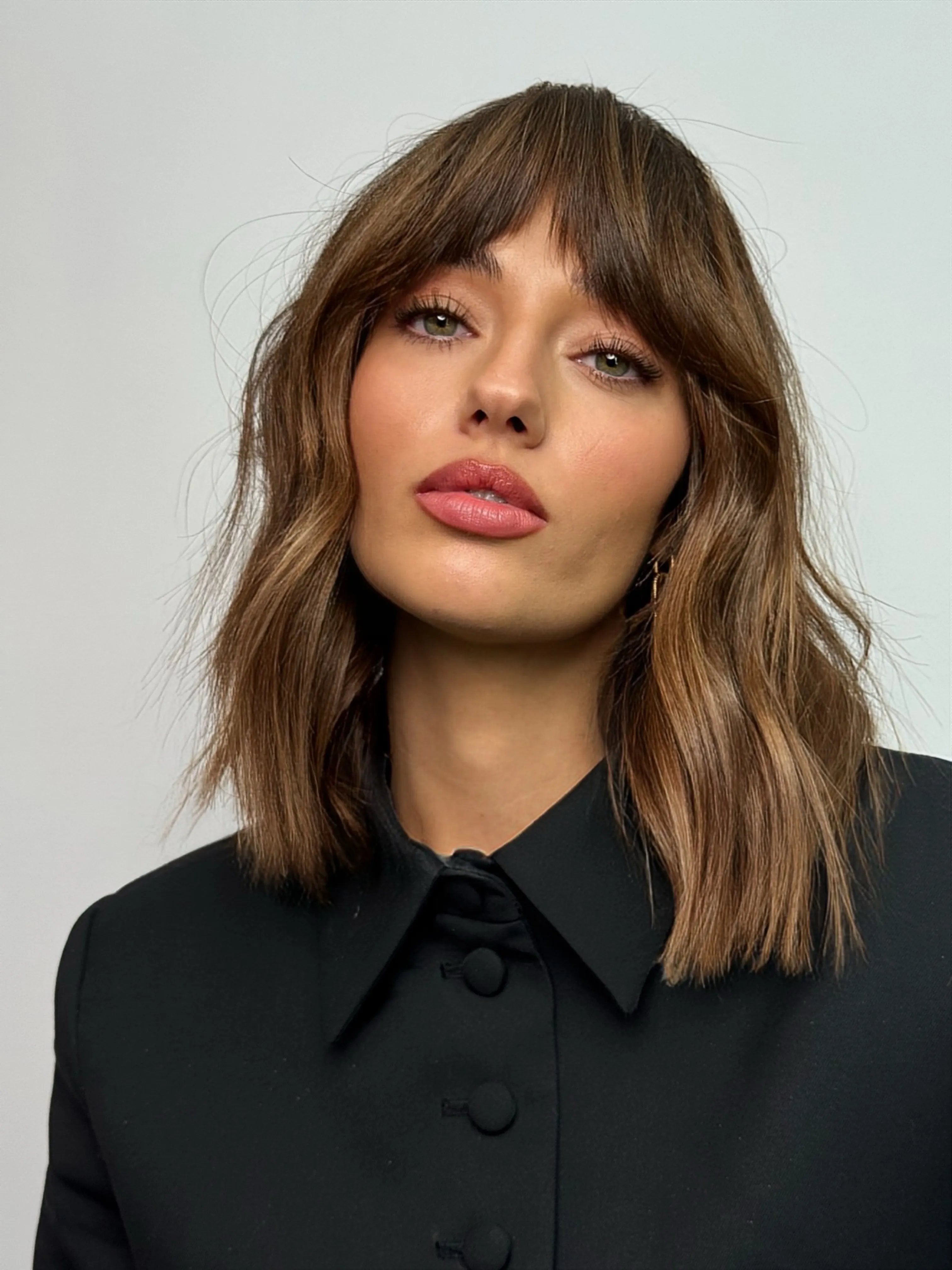 Wavy brown long bob with wispy bangs and shoulder-length ends