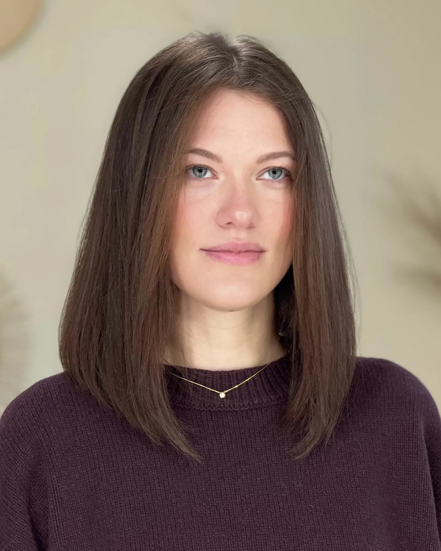 Straight brunette long bob with center part and blunt ends