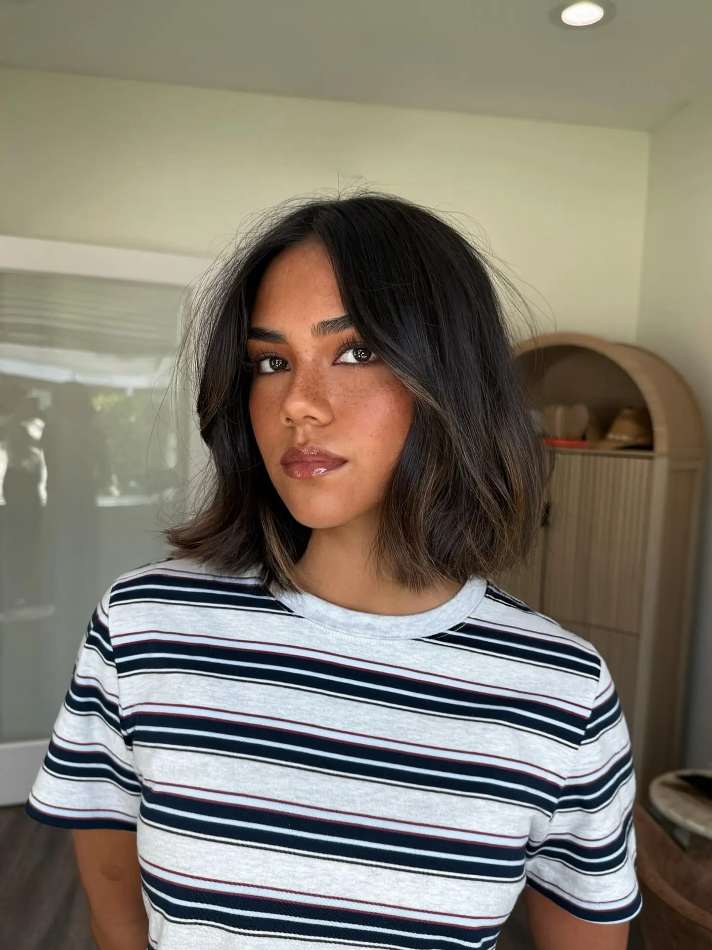 Dark long bob with center part, face-framing layers and flicked ends