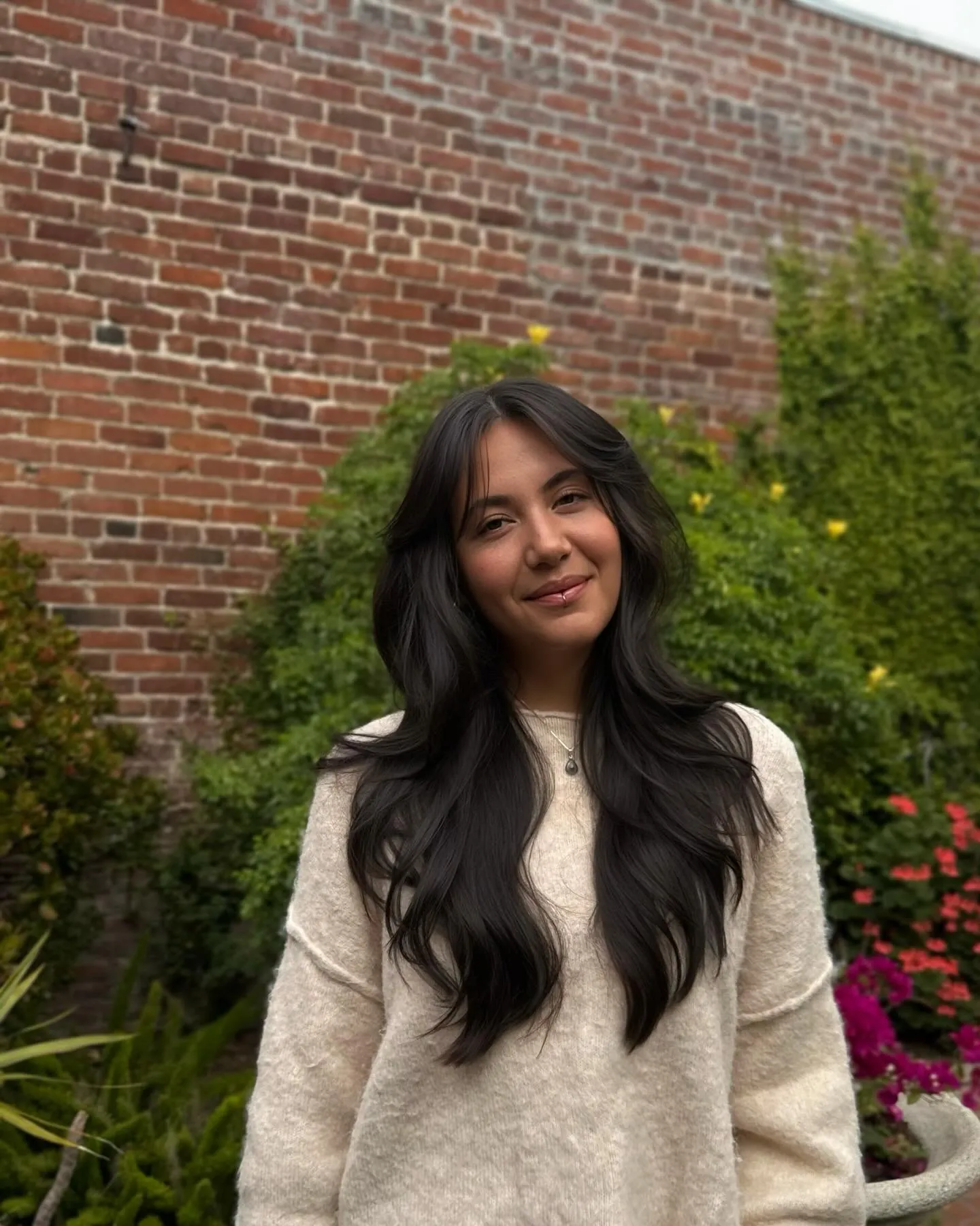 Long black hair with curtain bangs and large soft waves