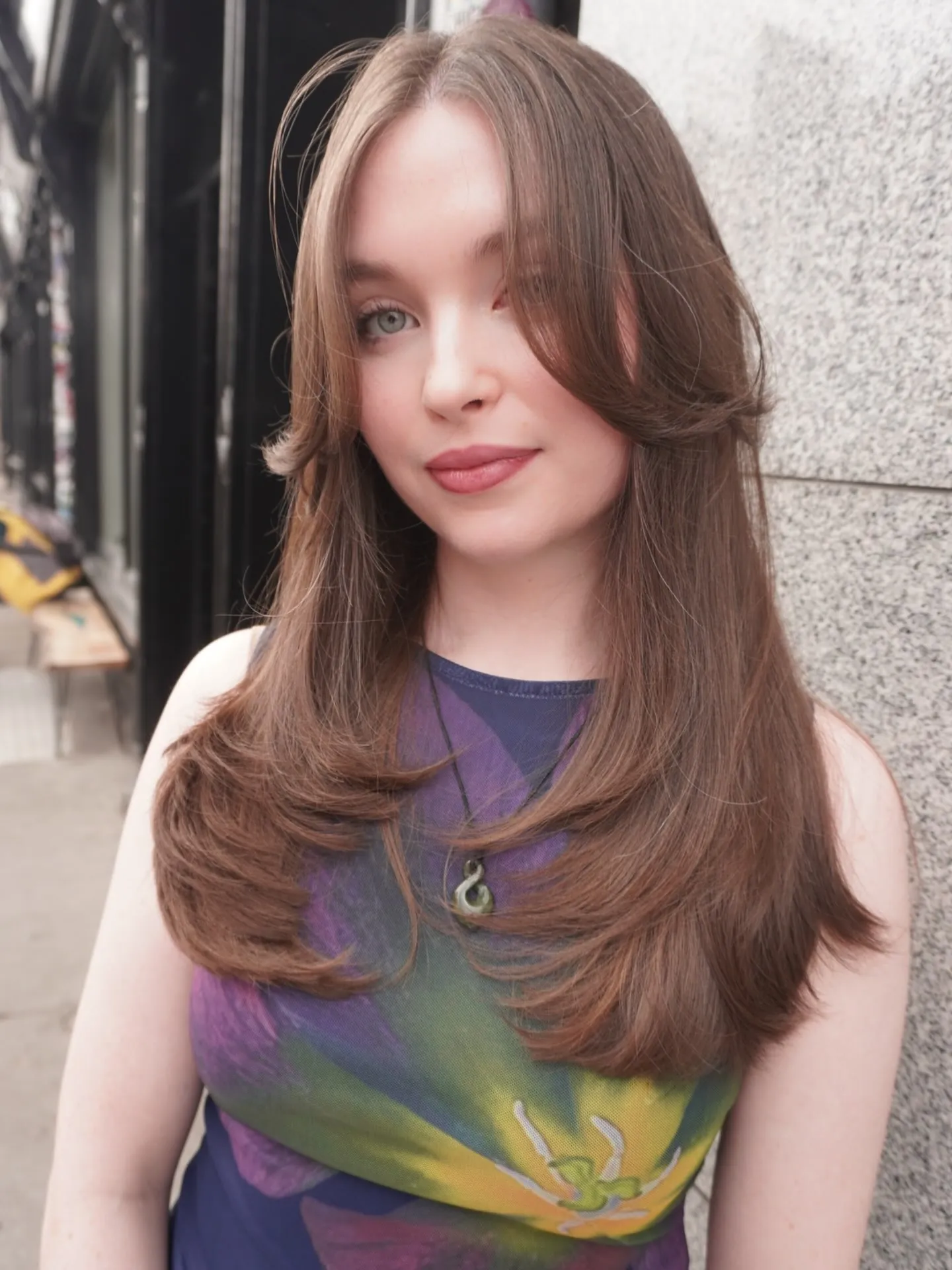 Long brunette hair with feathered face-framing layers