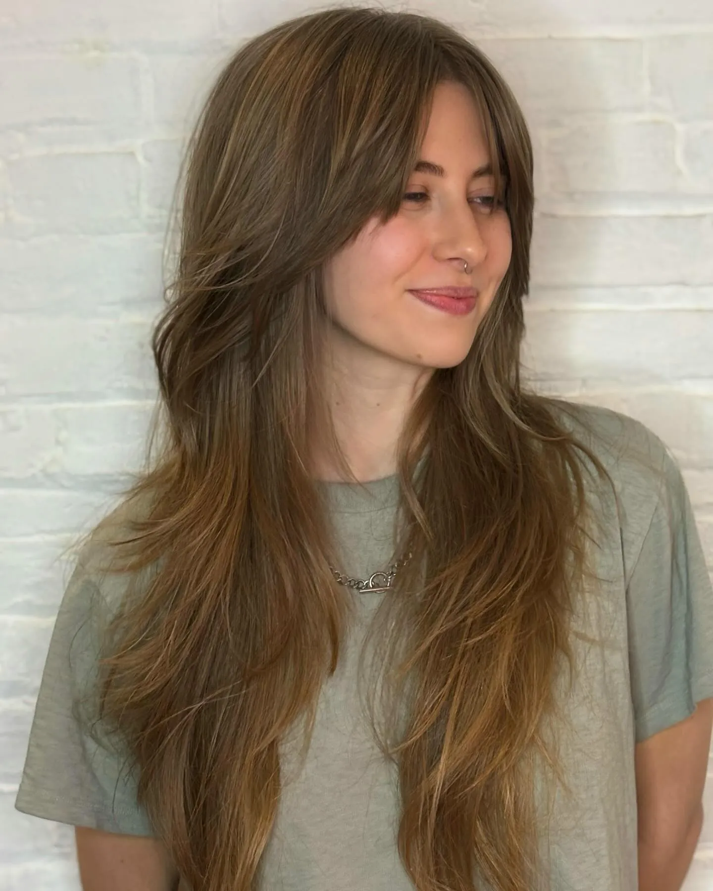 Long light brown hair with curtain layers and feathered lengths
