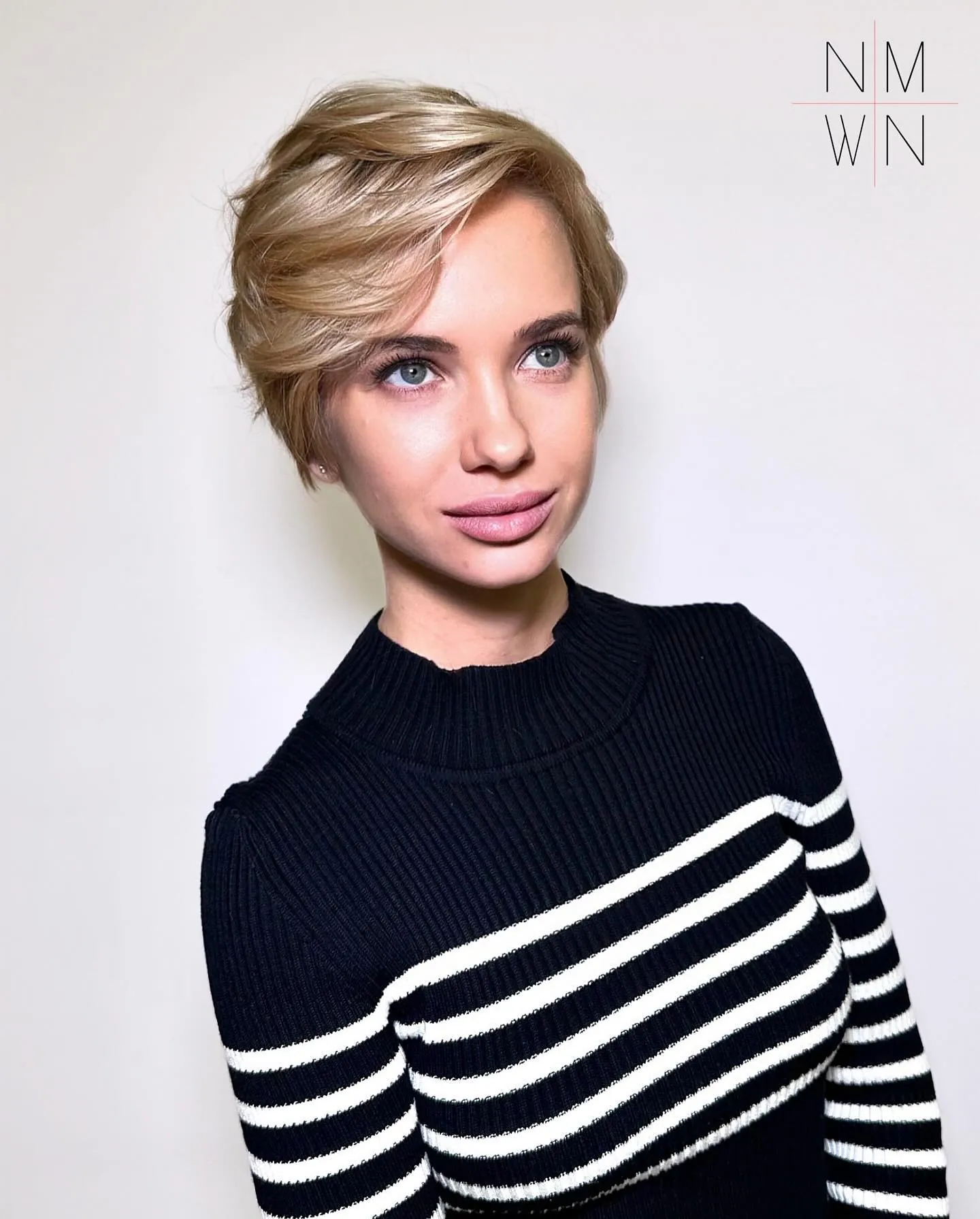 Side-swept blonde long pixie with a short nape