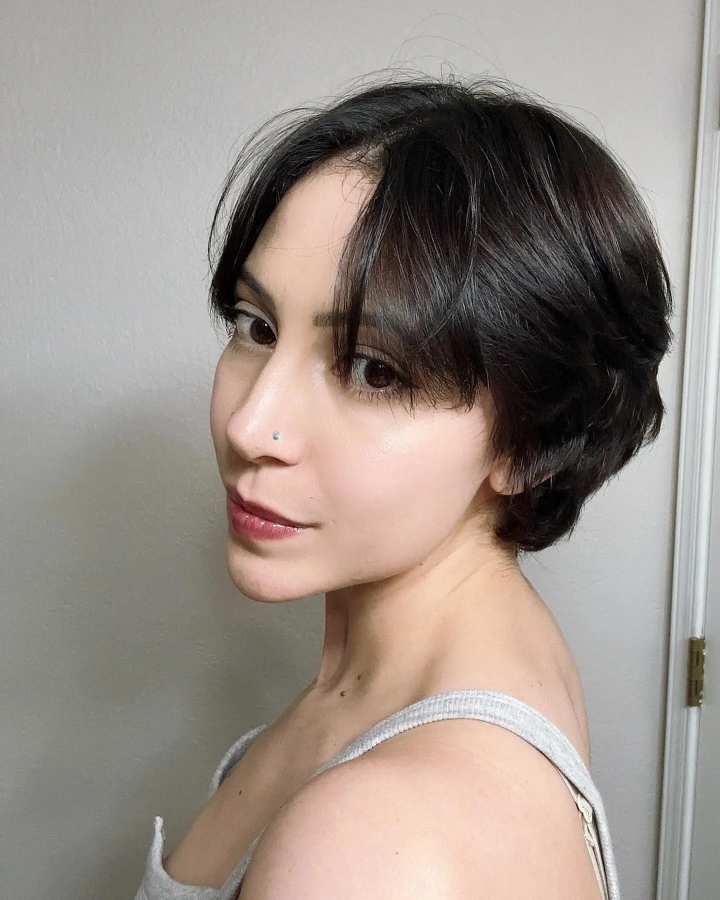 Center-parted dark pixie bob with curtain fringe