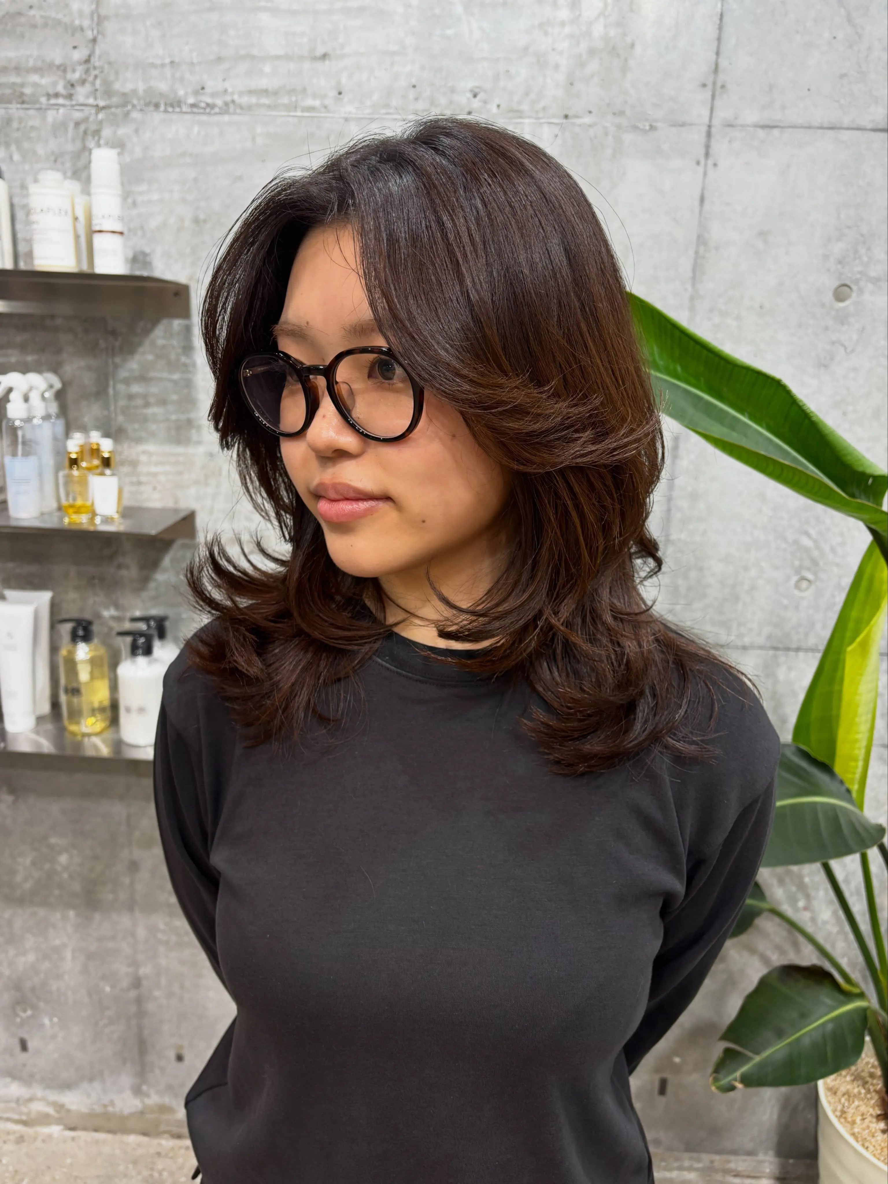 Dark medium layers with curtain bangs and flipped ends