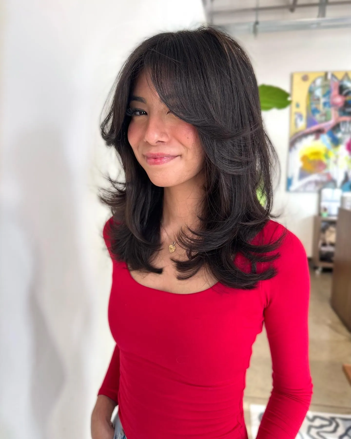 Dark rounded butterfly layers with long curtain bangs